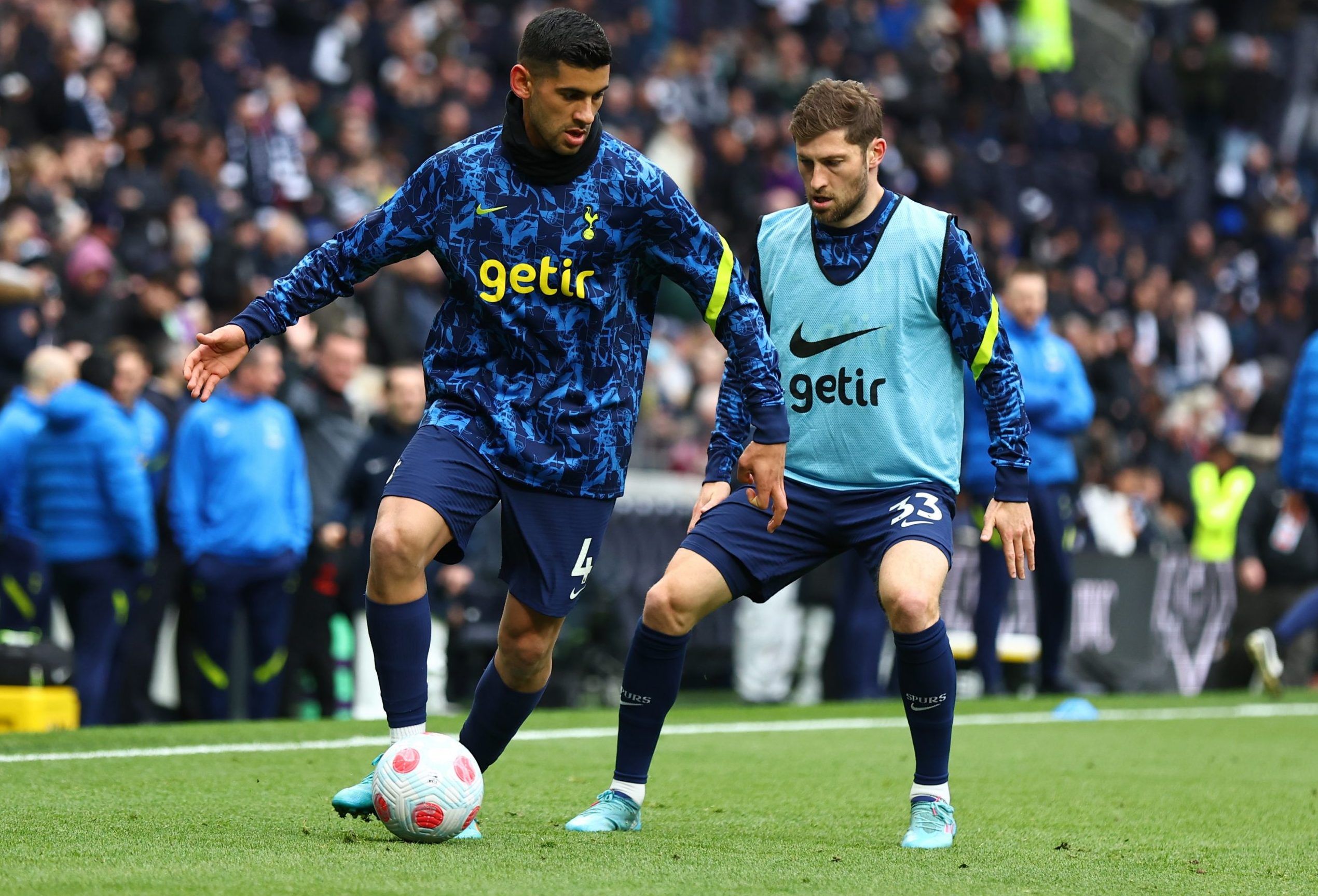 Spurs defender Cristian Romero on the ball during pre-game warm up alongside Ben Davies