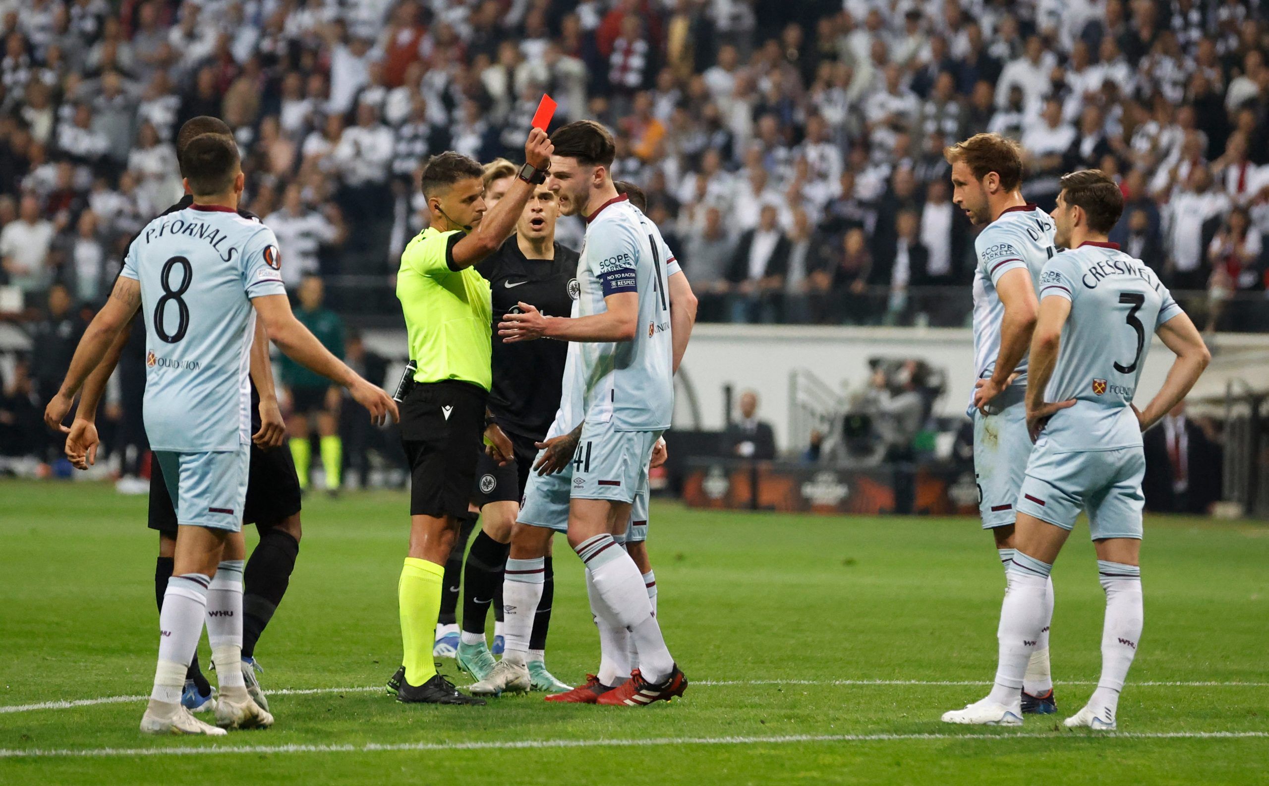 Soccer Football - Europa League - Semi Final - Second Leg - Eintracht Frankfurt v West Ham United - Deutsche Bank Park, Frankfurt, Germany - May 5, 2022 West Ham United's Aaron Cresswell is shown a red card by referee Jesus Gil Manzano after a VAR review Action Images via Reuters/Peter Cziborra