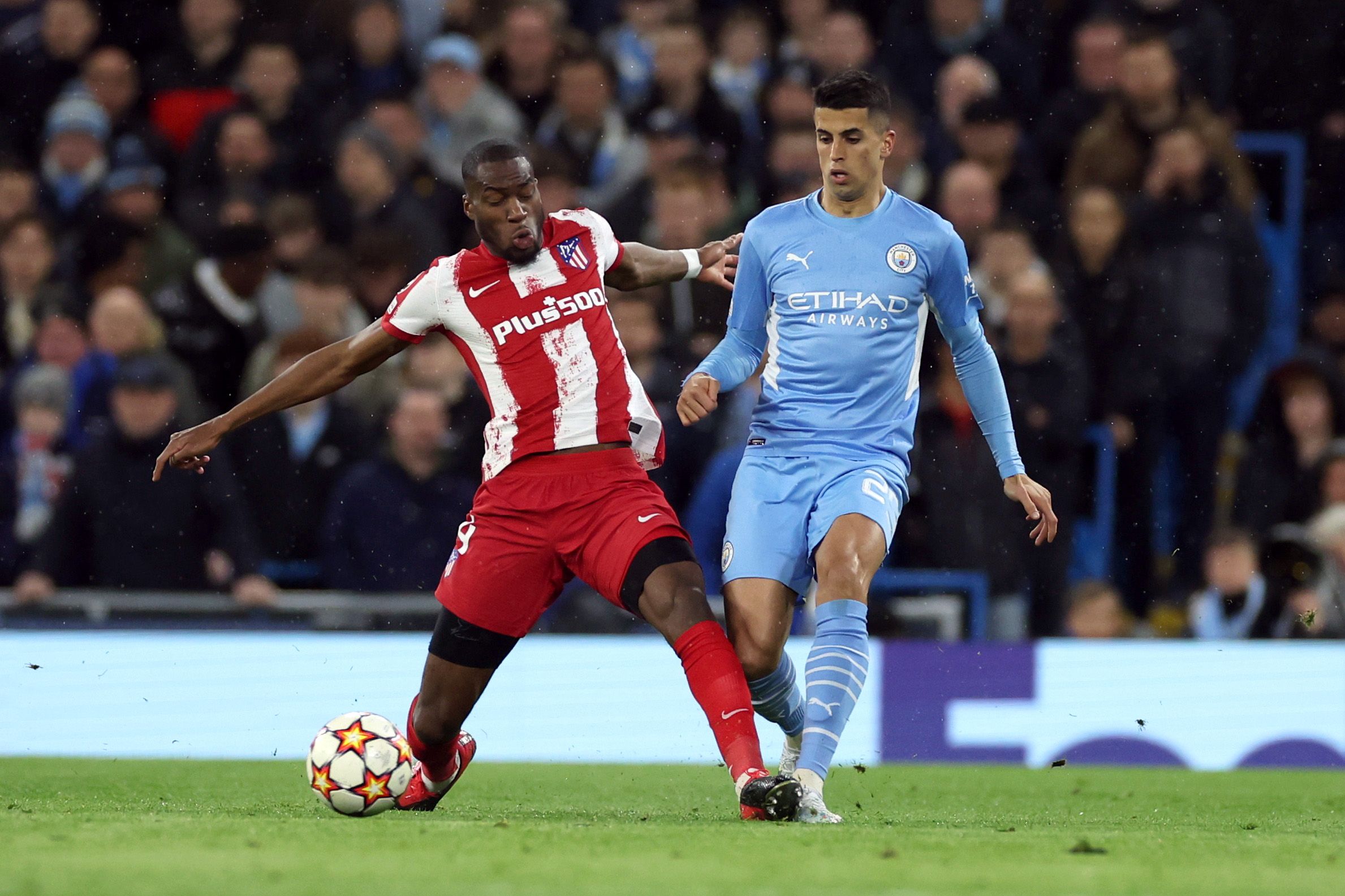 Soccer Football - Champions League - Quarter-Final - First Leg - Manchester City v Atletico Madrid - Etihad Stadium, Manchester, Britain - April 5, 2022 Manchester City's Joao Cancelo in action with Atletico Madrid's Geoffrey Kondogbia REUTERS/Phil Noble