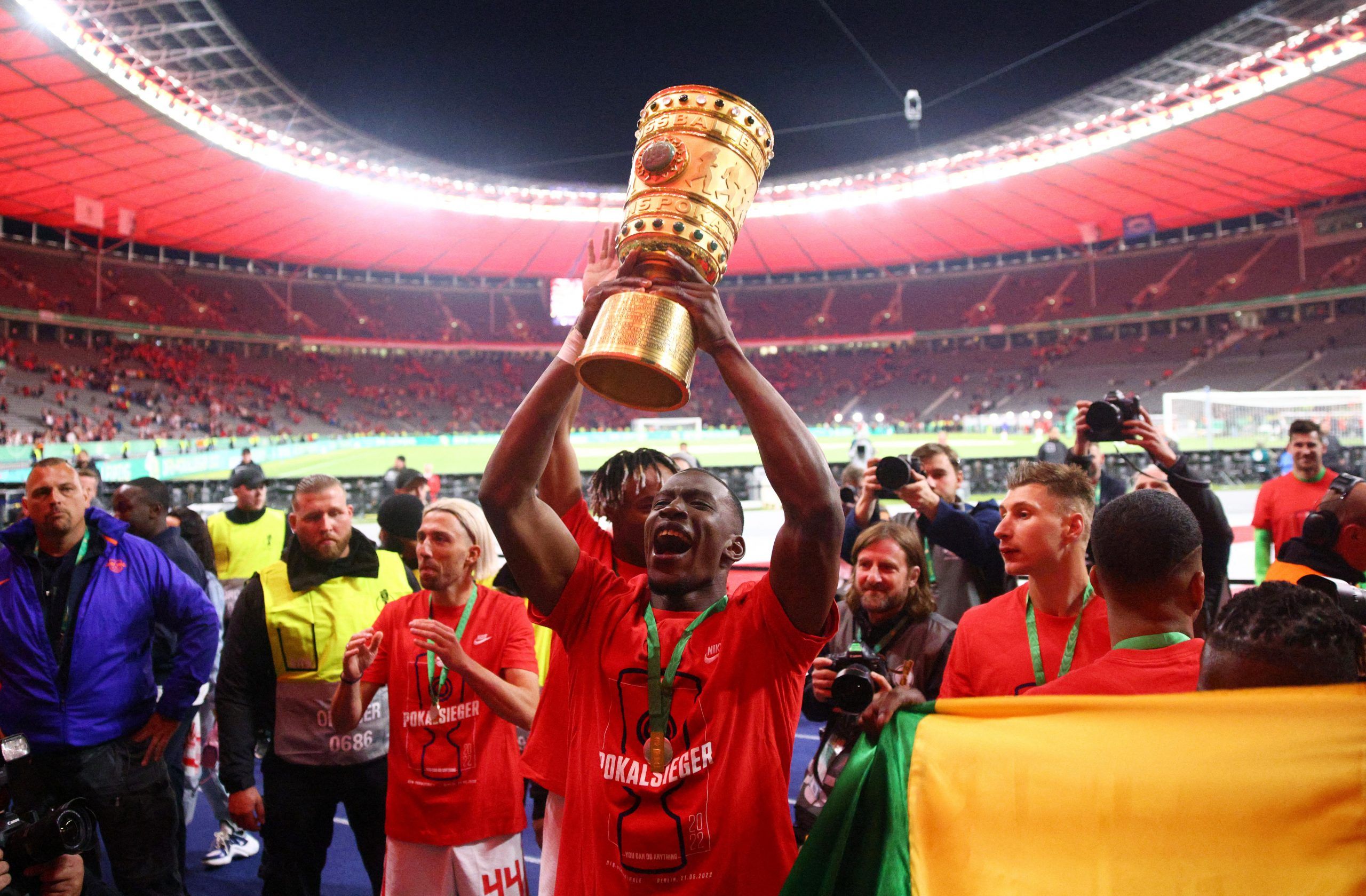 Soccer Football - DFB Cup - Final - SC Freiburg v RB Leipzig - Olympiastadion, Berlin, Germany - May 21, 2022  RB Leipzig's Nordi Mukiele celebrates with the trophy after winning the DFB Cup REUTERS/Lisi Niesner DFB REGULATIONS PROHIBIT ANY USE OF PHOTOGRAPHS AS IMAGE SEQUENCES AND/OR QUASI-VIDEO.