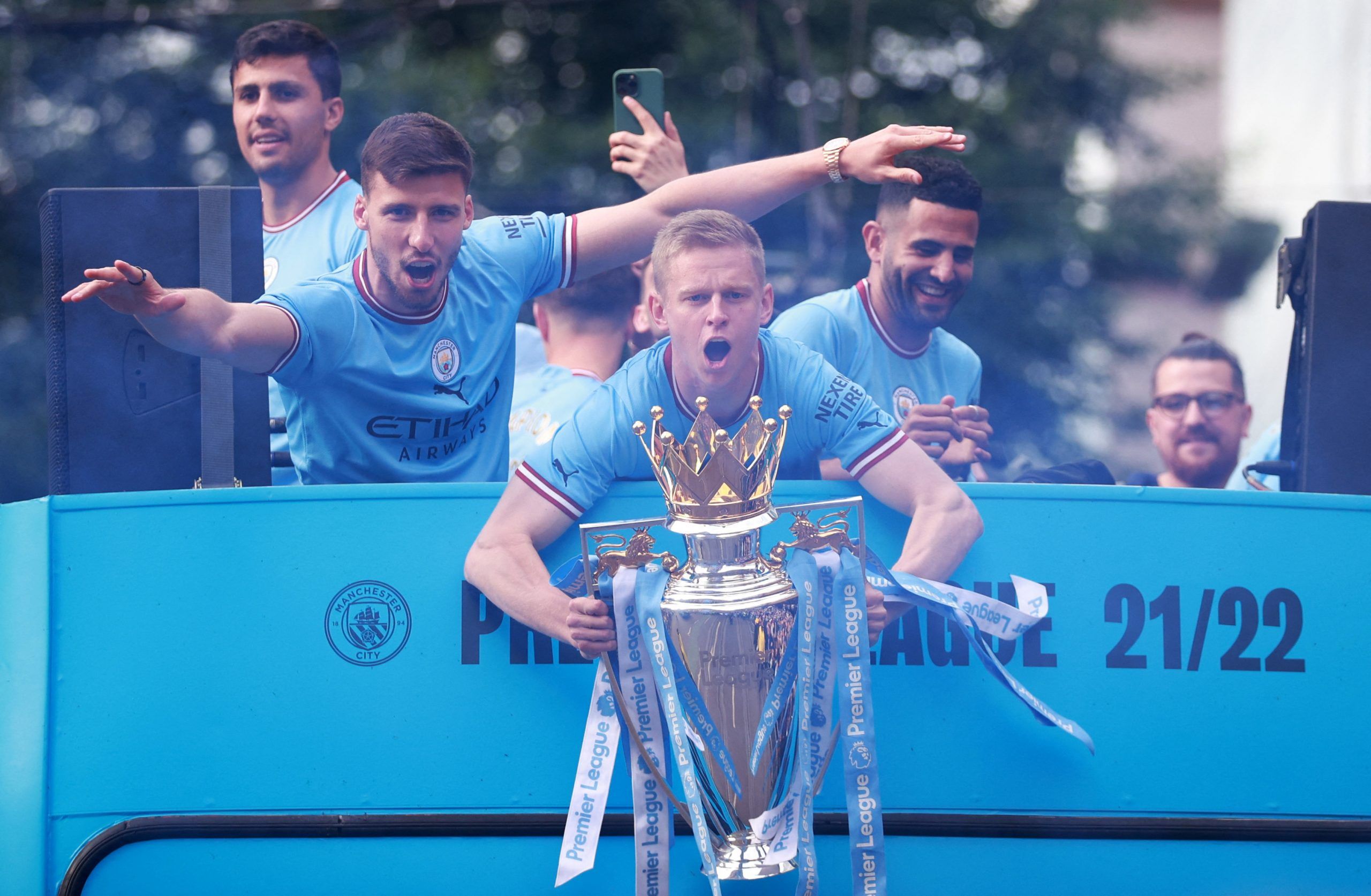 Soccer Football - Manchester City celebrate winning the Premier League - Manchester, Britain - May 23, 2022 Manchester City's Oleksandr Zinchenko, Riyad Mahrez and Ruben Dias celebrate with the Premier League trophy during the victory parade REUTERS/Hannah Mckay