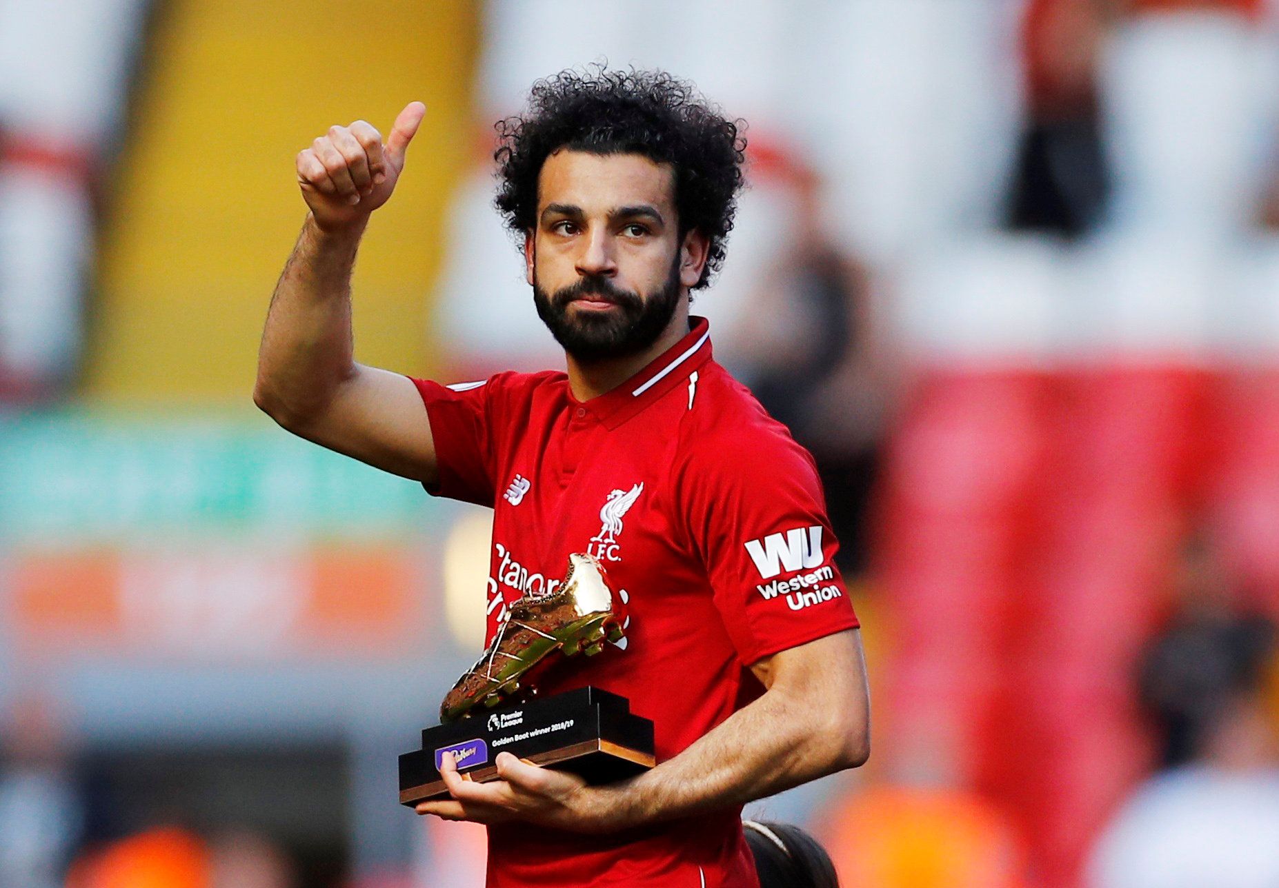 Soccer Football - Premier League - Liverpool v Wolverhampton Wanderers - Anfield, Liverpool, Britain - May 12, 2019  Liverpool's Mohamed Salah gestures to the fans as he holds a trophy for winning the Premier League Golden Boot award after the match  REUTERS/Phil Noble  EDITORIAL USE ONLY. No use with unauthorized audio, video, data, fixture lists, club/league logos or 