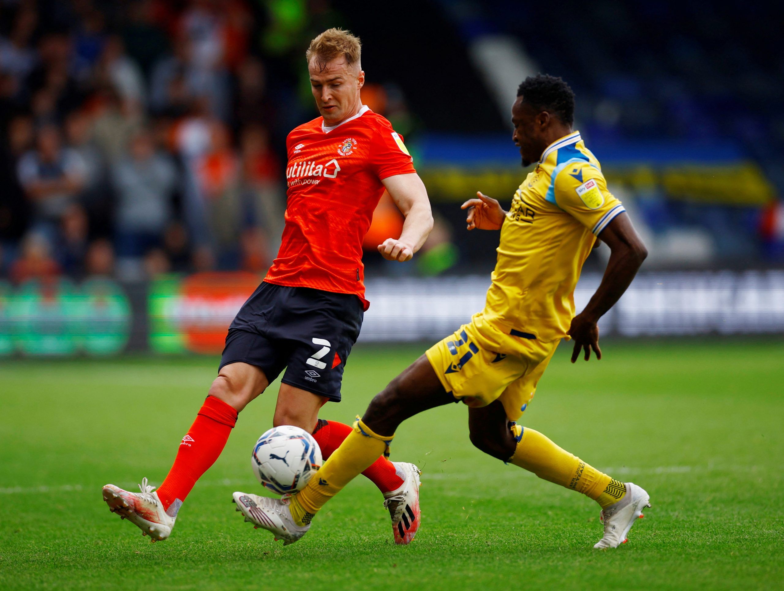 Soccer Football - Championship - Luton Town v Reading - Kenilworth Road, Luton, Britain - May 7, 2022 Luton Town's James Bree in action with Reading's Baba Rahman  Action Images/Andrew Boyers  EDITORIAL USE ONLY. No use with unauthorized audio, video, data, fixture lists, club/league logos or 