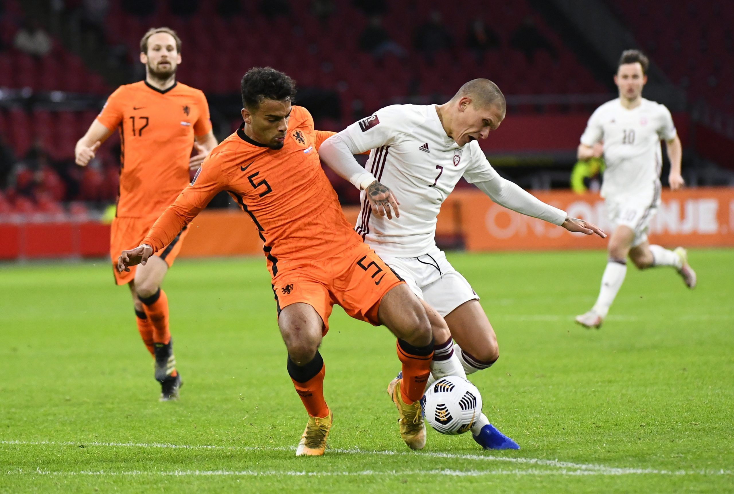 Soccer Football - World Cup Qualifiers Europe - Group G - Netherlands v Latvia - Amsterdam Arena, Amsterdam, Netherlands - March 27, 2021 Netherlands' Owen Wijndal in action with Latvia's Vladimirs Kamess REUTERS/Piroschka Van De Wouw