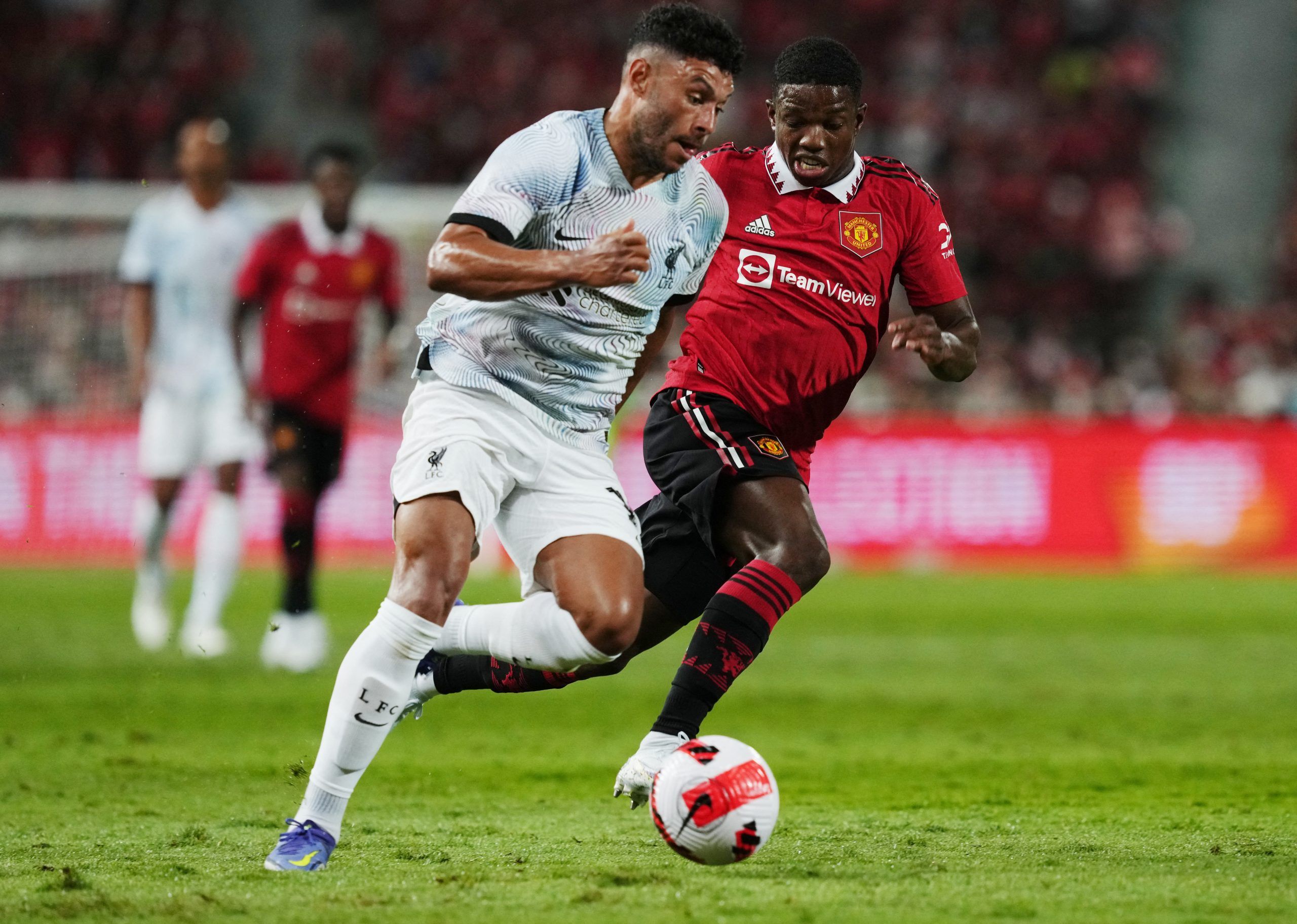 Soccer Football - Pre Season Friendly - Manchester United v Liverpool - Rajamangala National Stadium, Bangkok, Thailand - July 12, 2022 Liverpool's Alex Oxlade-Chamberlain in action with Manchester United's Tyrell Malacia REUTERS/Athit Perawongmetha