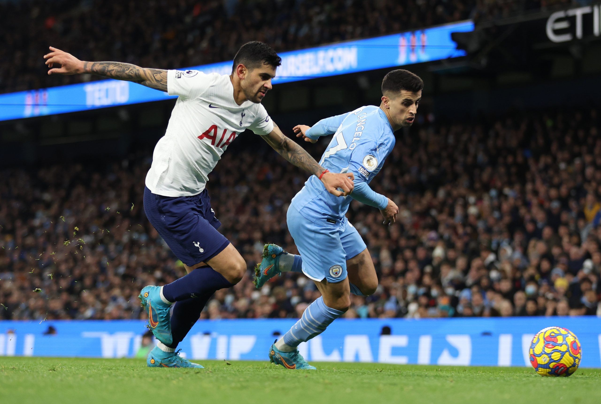 Soccer Football - Premier League - Manchester City v Tottenham Hotspur - Etihad Stadium, Manchester, Britain - February 19, 2022 Manchester City's Joao Cancelo in action with Tottenham Hotspur's Cristian Romero Action Images via Reuters/Carl Recine EDITORIAL USE ONLY. No use with unauthorized audio, video, data, fixture lists, club/league logos or 'live' services. Online in-match use limited to 75 images, no video emulation. No use in betting, games or single club /league/player publications.  P
