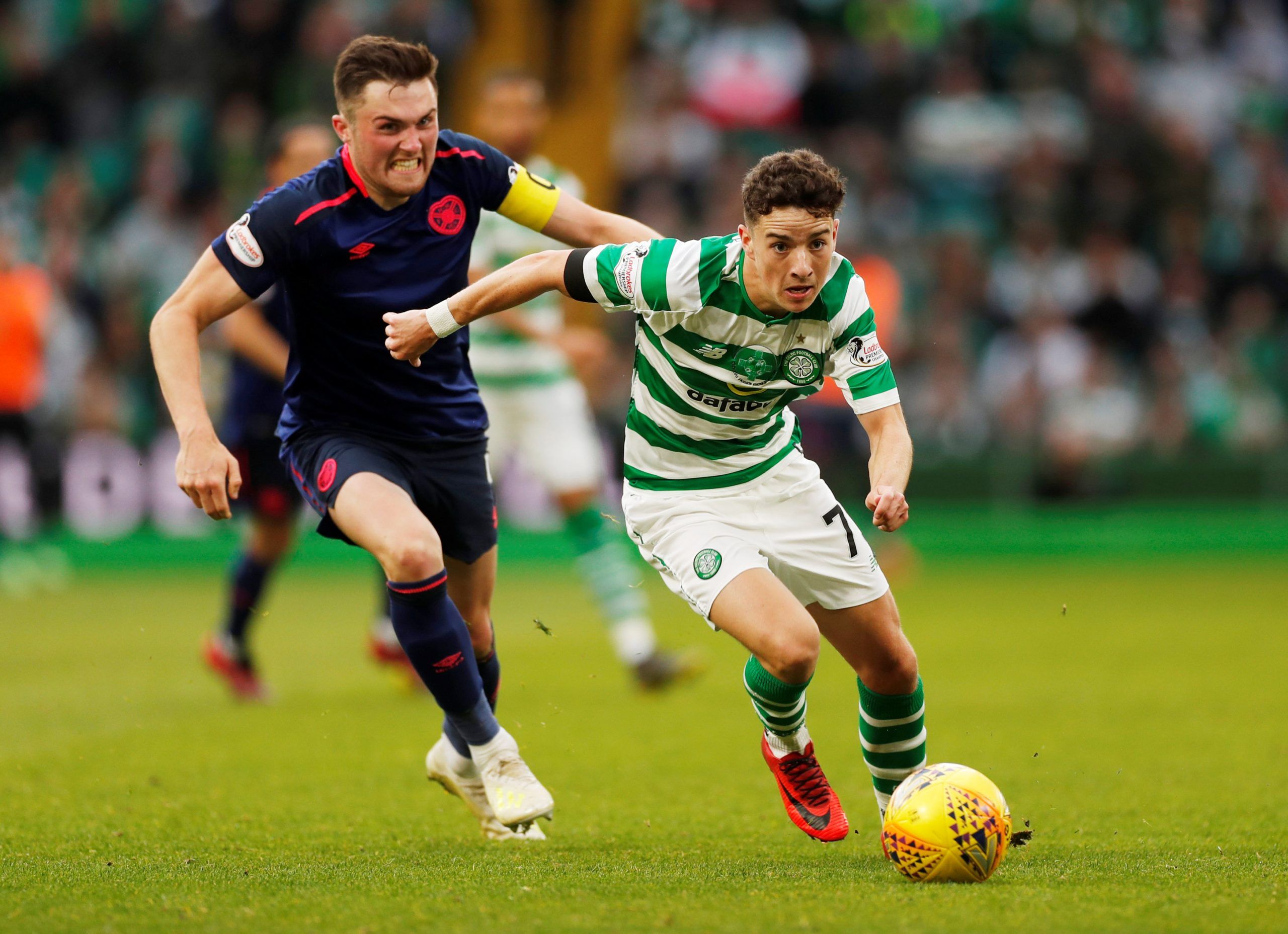 Soccer Football - Premiership - Celtic v Heart of Midlothian - Celtic Park, Glasgow, Britain - May 19, 2019  Celtic's Mikey Johnston in action with Heart of Midlothian's John Souttar  Action Images via Reuters/Lee Smith