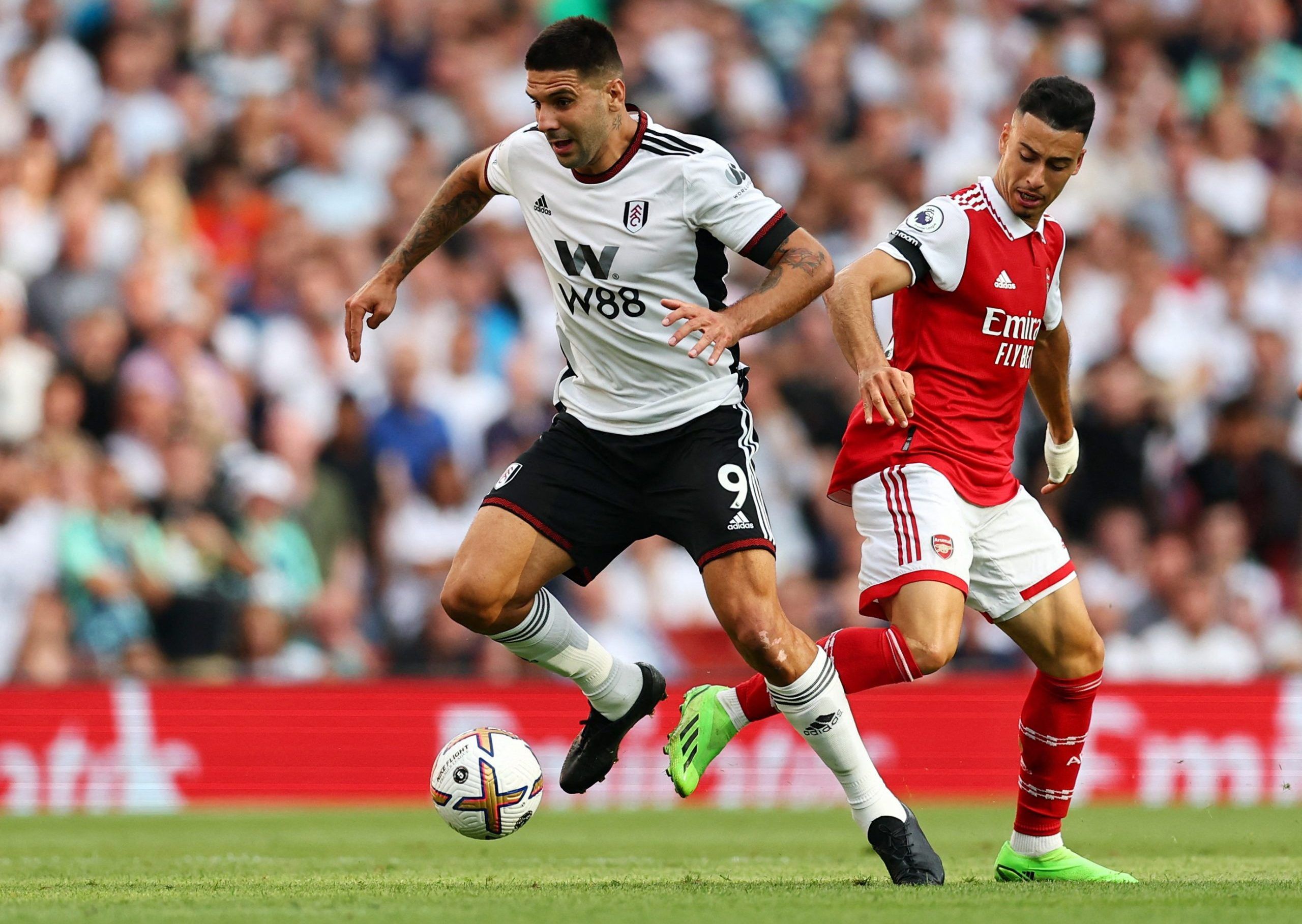 Soccer Football - Premier League - Arsenal v Fulham - Emirates Stadium, London, Britain - August 27, 2022 Fulham's Aleksandar Mitrovic in action with Arsenal's Gabriel Martinelli REUTERS/David Klein EDITORIAL USE ONLY. No use with unauthorized audio, video, data, fixture lists, club/league logos or 'live' services. Online in-match use limited to 75 images, no video emulation. No use in betting, games or single club /league/player publications.  Please contact your account representative for furt