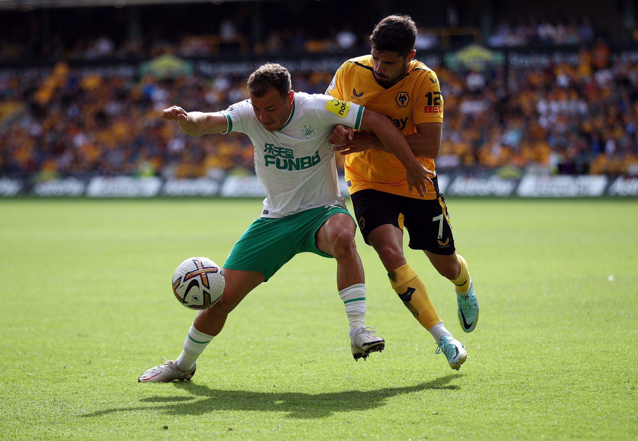 Soccer Football - Premier League - Wolverhampton Wanderers v Newcastle United - Molineux Stadium, Wolverhampton, Britain - August 28, 2022 Newcastle United's Ryan Fraser in action with Wolverhampton Wanderers' Pedro Neto Action Images via Reuters/Molly Darlington EDITORIAL USE ONLY. No use with unauthorized audio, video, data, fixture lists, club/league logos or 'live' services. Online in-match use limited to 75 images, no video emulation. No use in betting, games or single club /league/player p