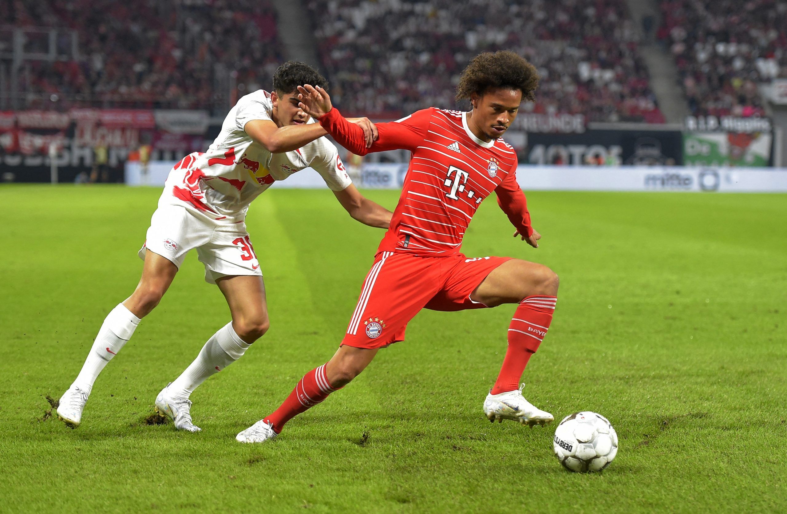 Soccer Football - DFL Super Cup - RB Leipzig v Bayern Munich - Red Bull Arena, Leipzig, Germany - July 30, 2022  RB Leipzig's Hugo Novoa in action with Bayern Munich's Leroy Sane REUTERS/Matthias Rietschel DFL REGULATIONS PROHIBIT ANY USE OF PHOTOGRAPHS AS IMAGE SEQUENCES AND/OR QUASI-VIDEO.