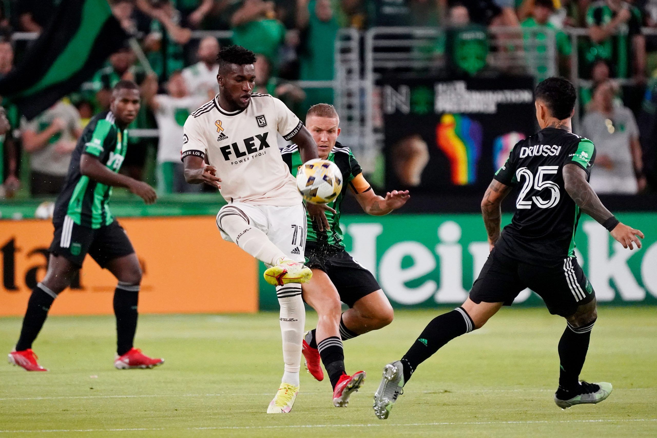 Sep 15, 2021; Austin, Texas, USA; Los Angeles FC midfielder Jose Cifuentes (11) controls the ball in front of Austin FC midfielder Alexander Ring (8) as forward Sebastian Driussi (25) closes in during the first half at Q2 Stadium. Mandatory Credit: Scott Wachter-USA TODAY Sports