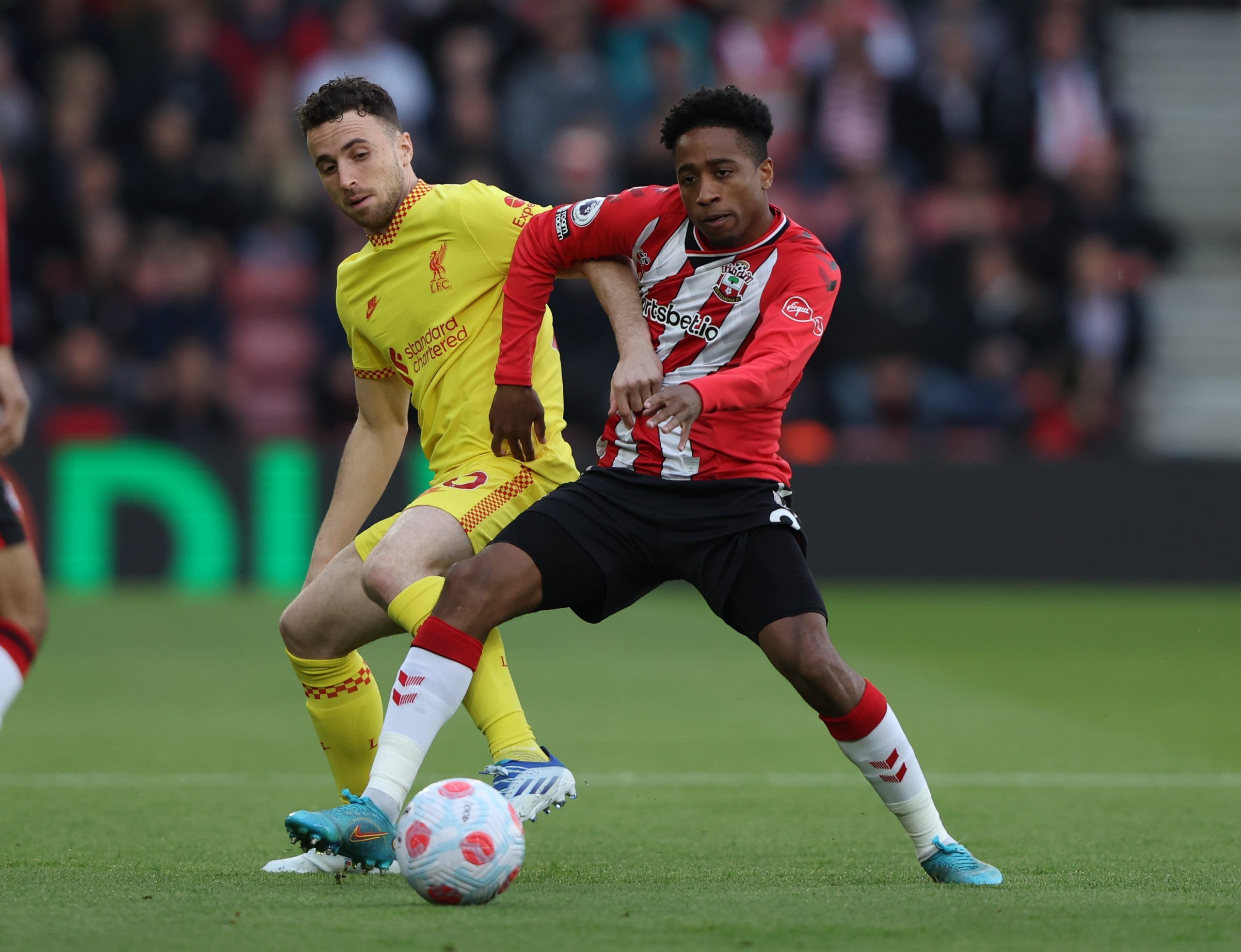 Soccer Football - Premier League - Southampton v Liverpool - St Mary's Stadium, Southampton, Britain - May 17, 2022 Liverpool's Diogo Jota in action with Southampton's Kyle Walker-Peters REUTERS/Ian Walton EDITORIAL USE ONLY. No use with unauthorized audio, video, data, fixture lists, club/league logos or 'live' services. Online in-match use limited to 75 images, no video emulation. No use in betting, games or single club /league/player publications.  Please contact your account representative f