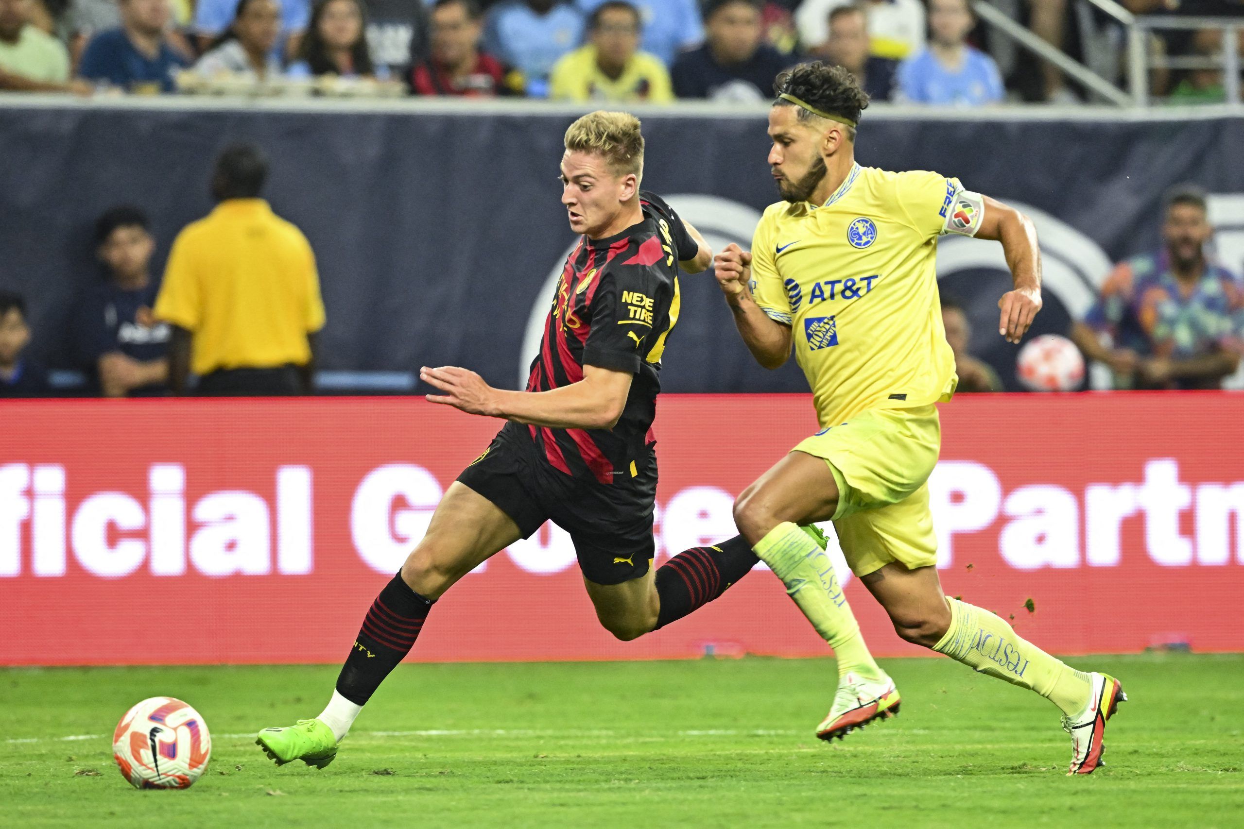 Jul 20, 2022; Houston, TX, USA; Manchester City forward Liam Delap (48) and Club America defender Bruno Valdez (18) battle for the ball during the second half at NRG Stadium. Mandatory Credit: Maria Lysaker-USA TODAY Sports