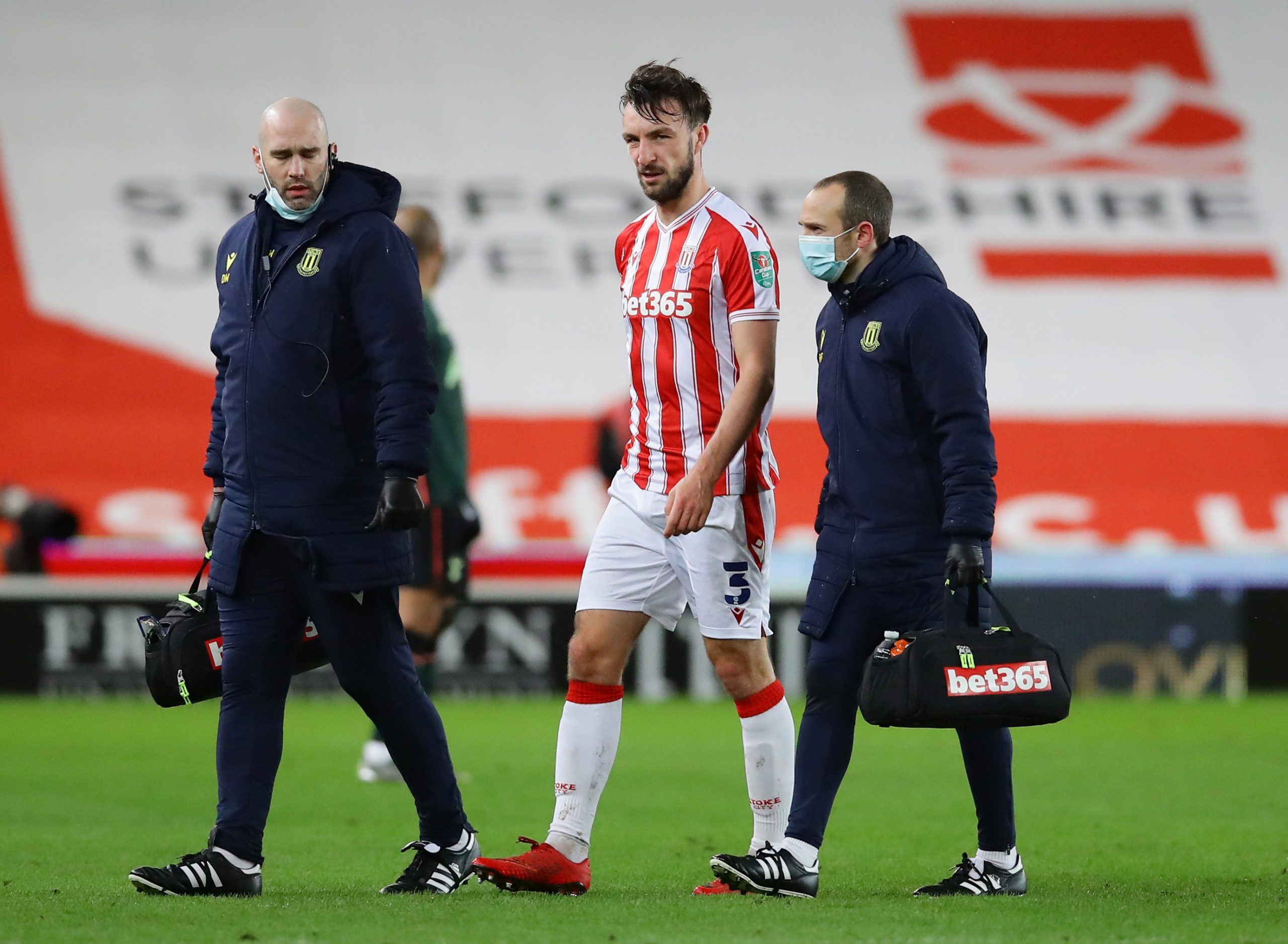 Soccer Football - Carabao Cup - Quarter-Final - Stoke City v Tottenham Hotspur - bet365 Stadium, Stoke-on-Trent, Britain - December 23, 2020 Stoke City's Morgan Fox walks off the pitch with medical staff after sustaining an injury REUTERS/David Klein EDITORIAL USE ONLY. No use with unauthorized audio, video, data, fixture lists, club/league logos or 'live' services. Online in-match use limited to 75 images, no video emulation. No use in betting, games or single club /league/player publications. 