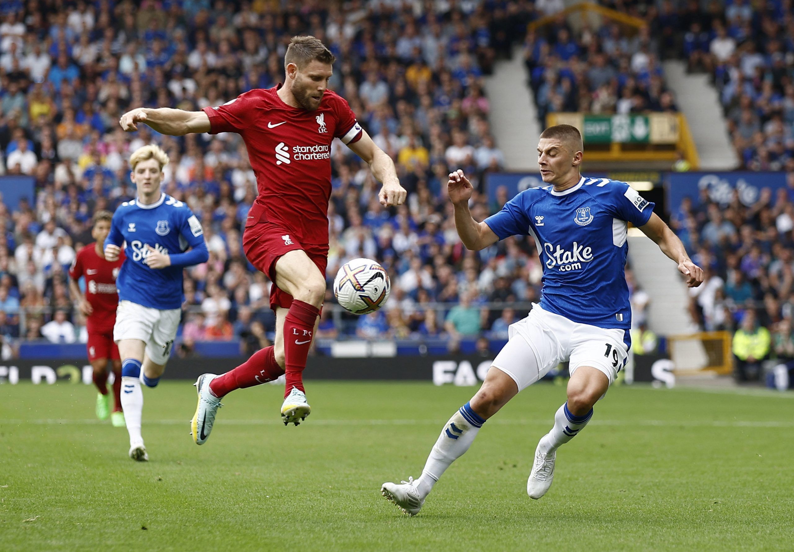 Soccer Football - Premier League - Everton v Liverpool - Goodison Park, Liverpool, Britain - September 3, 2022 Liverpool's James Milner in action with Everton's Vitaliy Mykolenko Action Images via Reuters/Jason Cairnduff EDITORIAL USE ONLY. No use with unauthorized audio, video, data, fixture lists, club/league logos or 'live' services. Online in-match use limited to 75 images, no video emulation. No use in betting, games or single club /league/player publications.  Please contact your account r