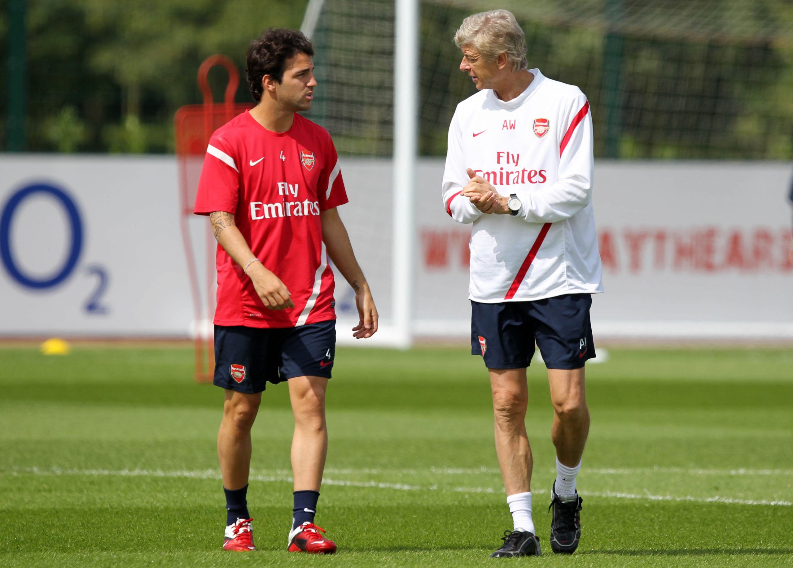 Arsenal's Cesc Fabregas (L) and manager Arsene Wenger during training