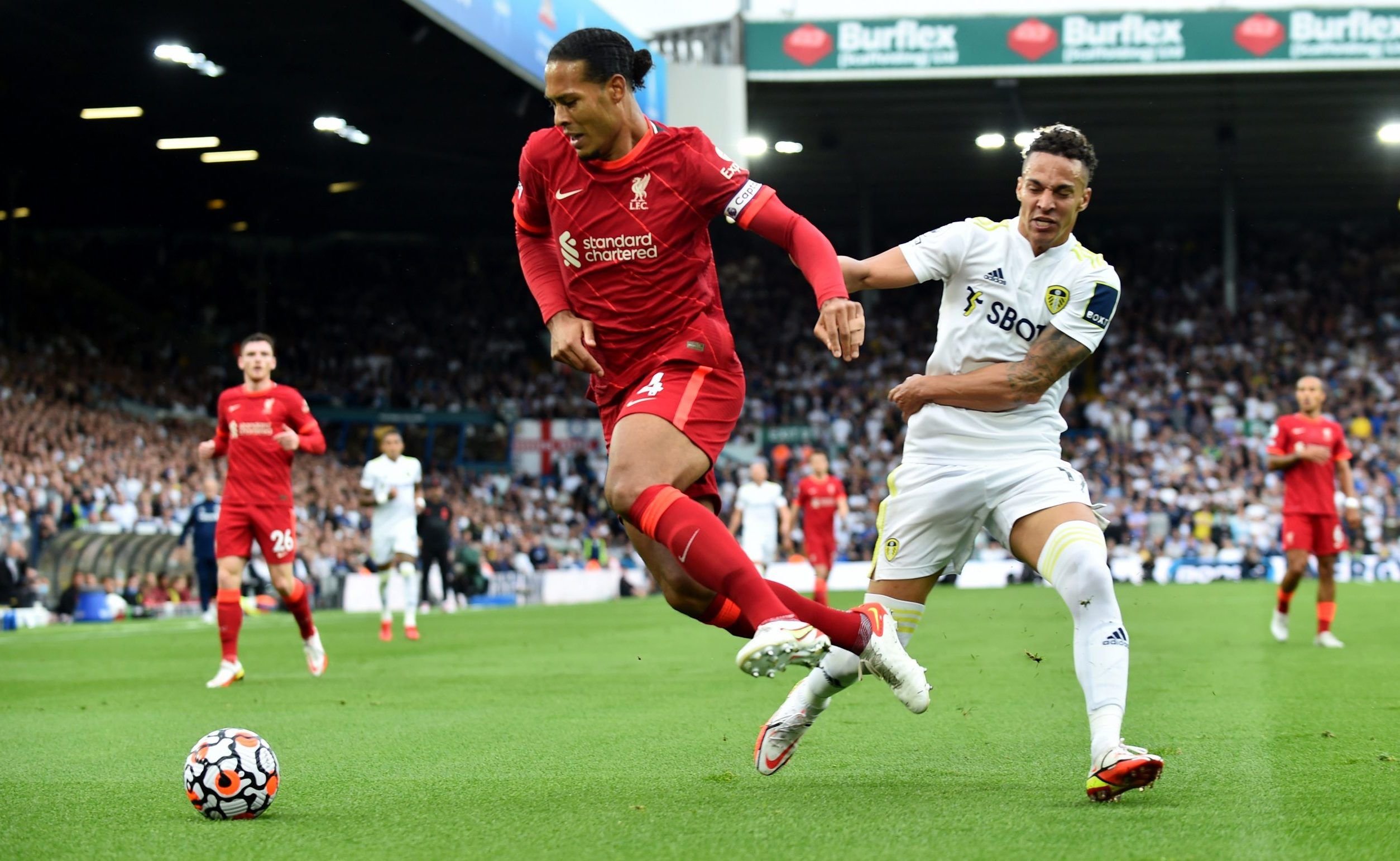 Liverpool's Virgil van Dijk in action with Leeds United's Rodrigo