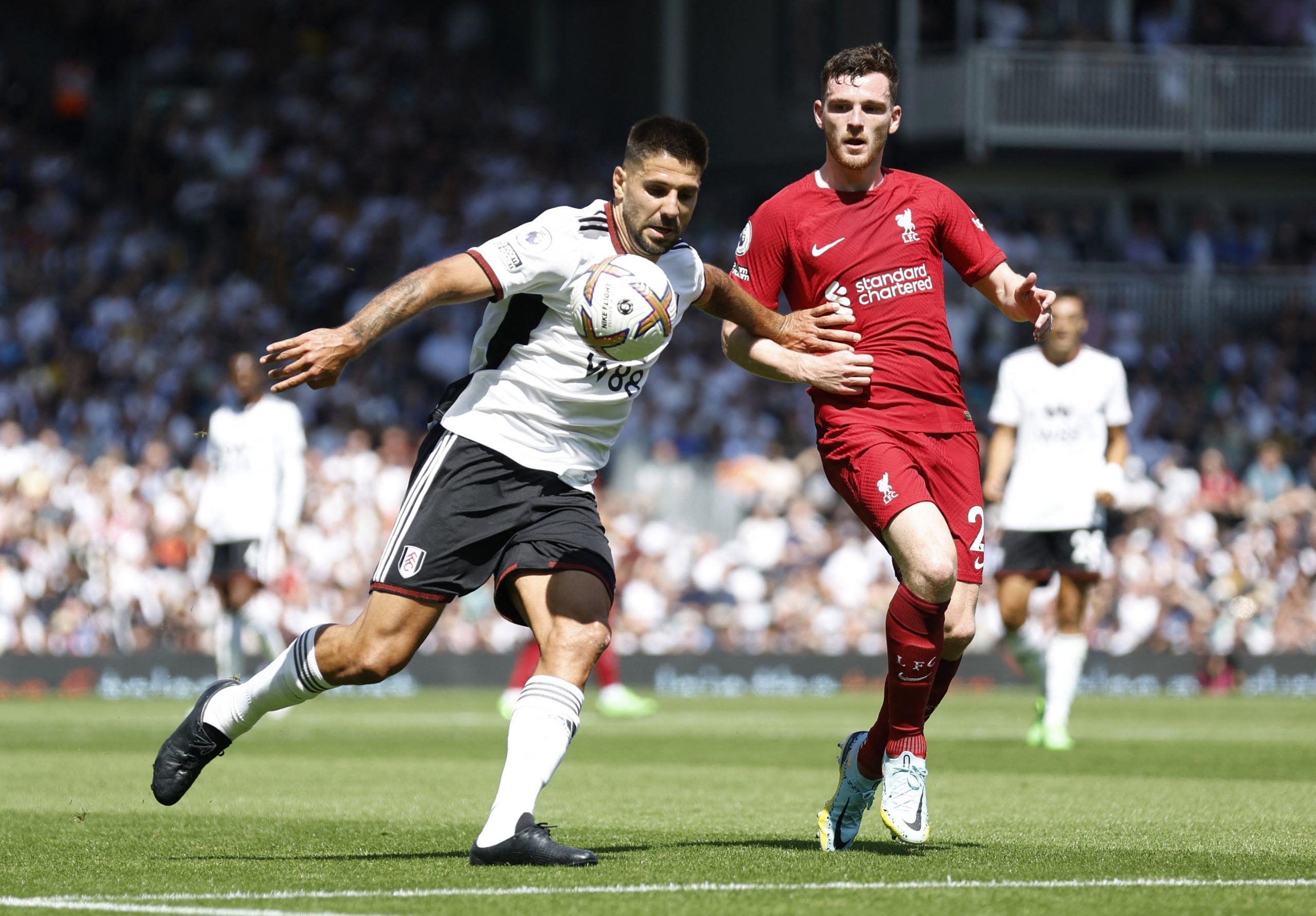 Soccer Football - Premier League - Fulham v Liverpool - Craven Cottage, London, Britain - August 6, 2022 Liverpool's Andrew Robertson in action with Fulham's Aleksandar Mitrovic Action Images via Reuters/Peter Cziborra EDITORIAL USE ONLY. No use with unauthorized audio, video, data, fixture lists, club/league logos or 'live' services. Online in-match use limited to 75 images, no video emulation. No use in betting, games or single club /league/player publications.  Please contact your account rep