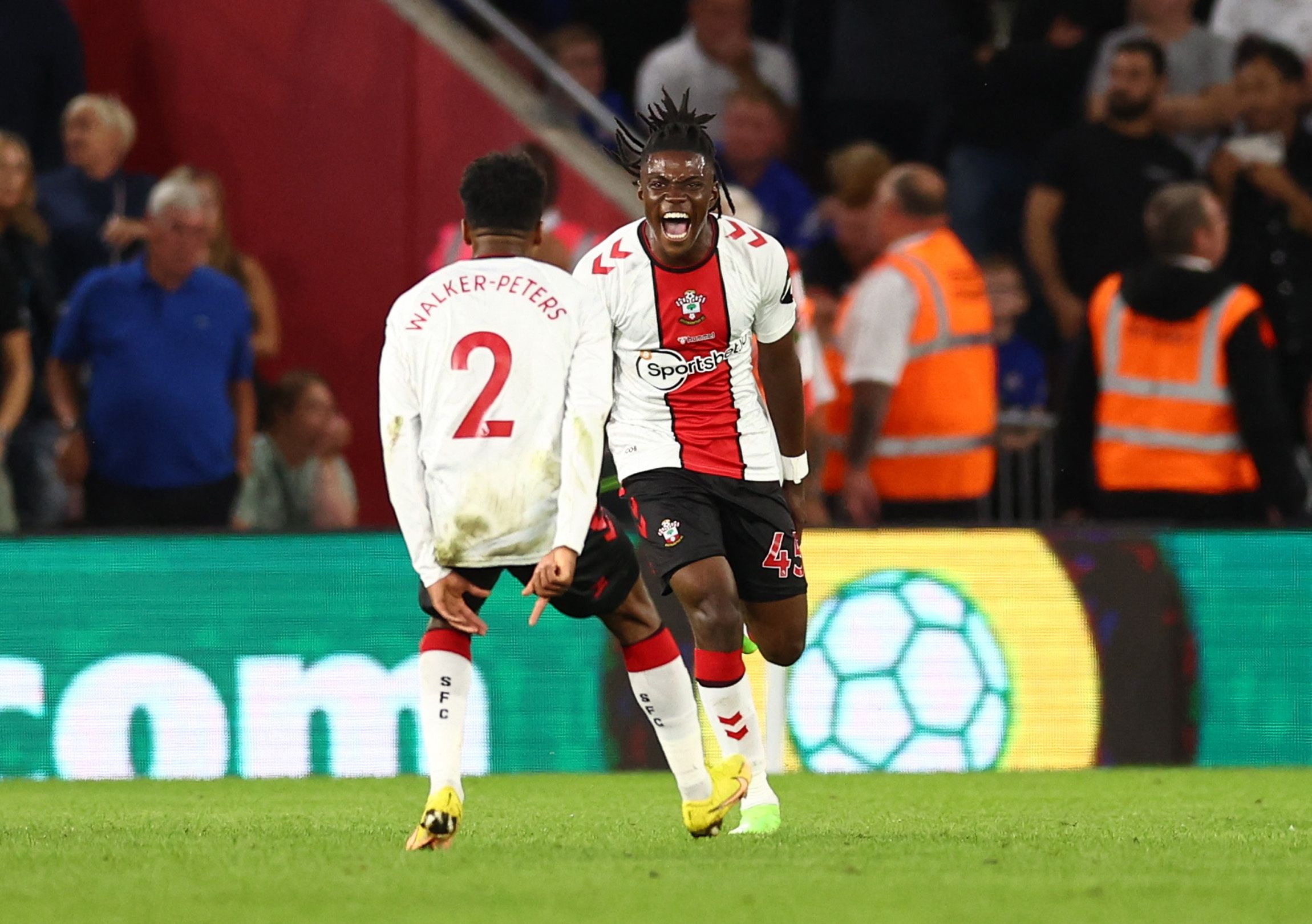 Soccer Football - Premier League - Southampton v Chelsea - St Mary's Stadium, Southampton, Britain - August 30, 2022 Southampton's Romeo Lavia celebrates scoring their first goal with Kyle Walker-Peters REUTERS/David Klein EDITORIAL USE ONLY. No use with unauthorized audio, video, data, fixture lists, club/league logos or 'live' services. Online in-match use limited to 75 images, no video emulation. No use in betting, games or single club /league/player publications.  Please contact your account