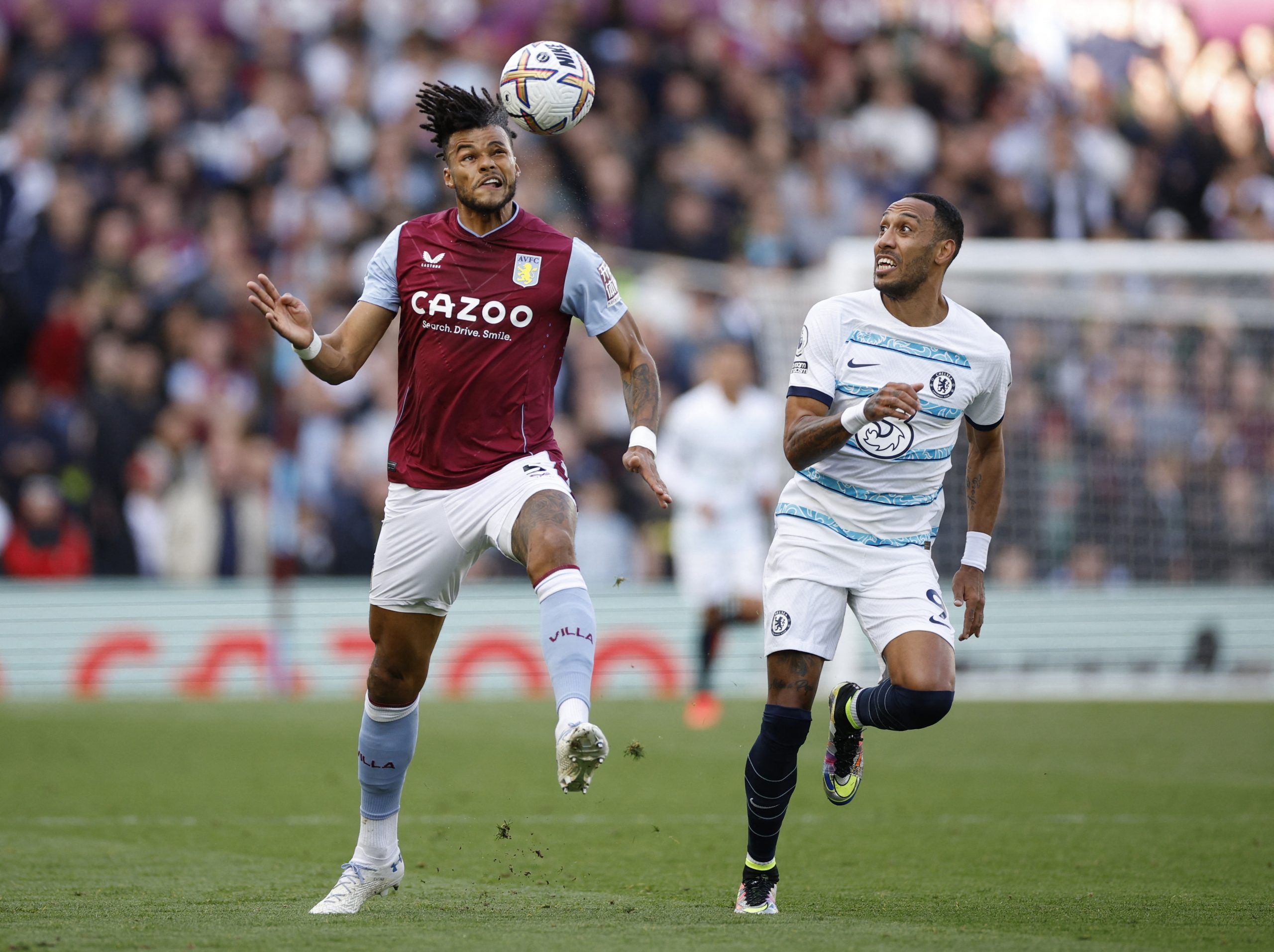 Soccer Football - Premier League - Aston Villa v Chelsea - Villa Park, Birmingham, Britain - October 16, 2022  Aston Villa's Tyrone Mings in action with Chelsea's Pierre-Emerick Aubameyang Action Images via Reuters/John Sibley EDITORIAL USE ONLY. No use with unauthorized audio, video, data, fixture lists, club/league logos or 'live' services. Online in-match use limited to 75 images, no video emulation. No use in betting, games or single club /league/player publications.  Please contact your acc