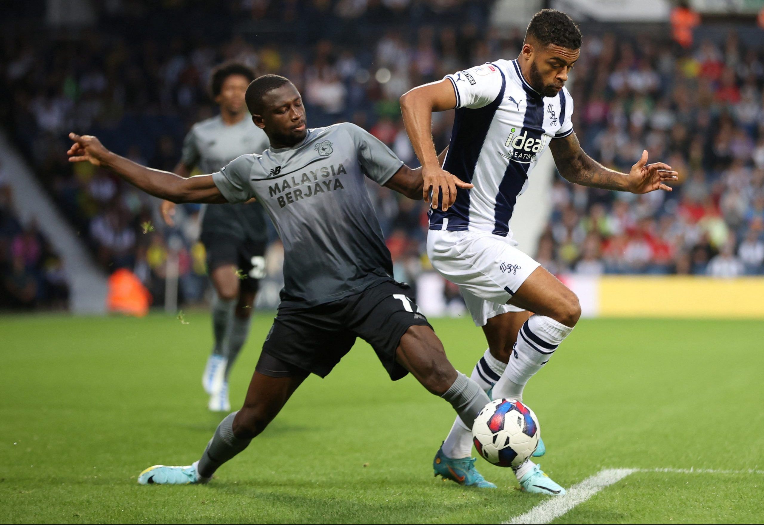 Soccer Football - Championship - West Bromwich Albion v Cardiff City - The Hawthorns, West Bromwich, Britain - August 17, 2022  Cardiff City's Jamilu Collins in action with West Bromwich Albion's Darnell Furlong  Action Images/Molly Darlington    EDITORIAL USE ONLY. No use with unauthorized audio, video, data, fixture lists, club/league logos or 