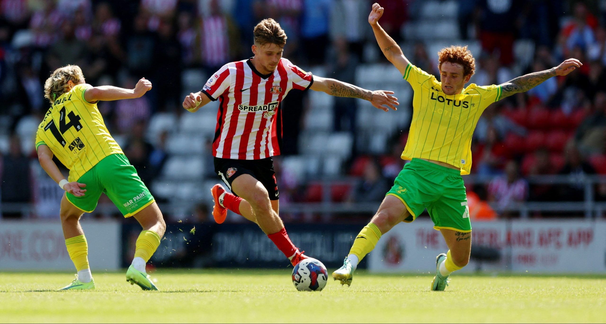 Soccer Football - Championship - Sunderland v Norwich City - Stadium of Light, Sunderland, Britain - August 27, 2022  Norwich City's Todd Cantwell and Joshua Sargent in action with Sunderland?s Dennis Cirkin  Action Images/Lee Smith  EDITORIAL USE ONLY. No use with unauthorized audio, video, data, fixture lists, club/league logos or 