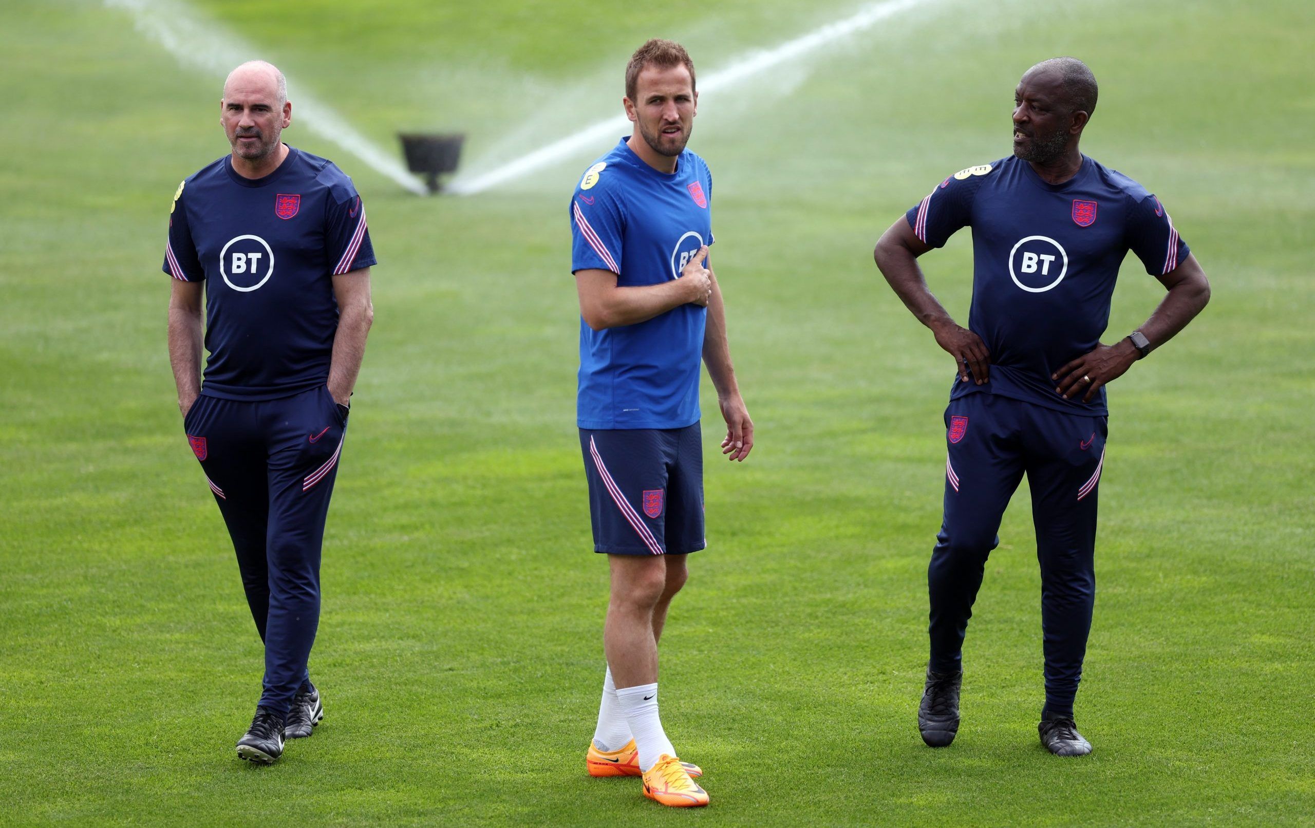 England's Harry Kane with assistant coach Chris Powell during training 