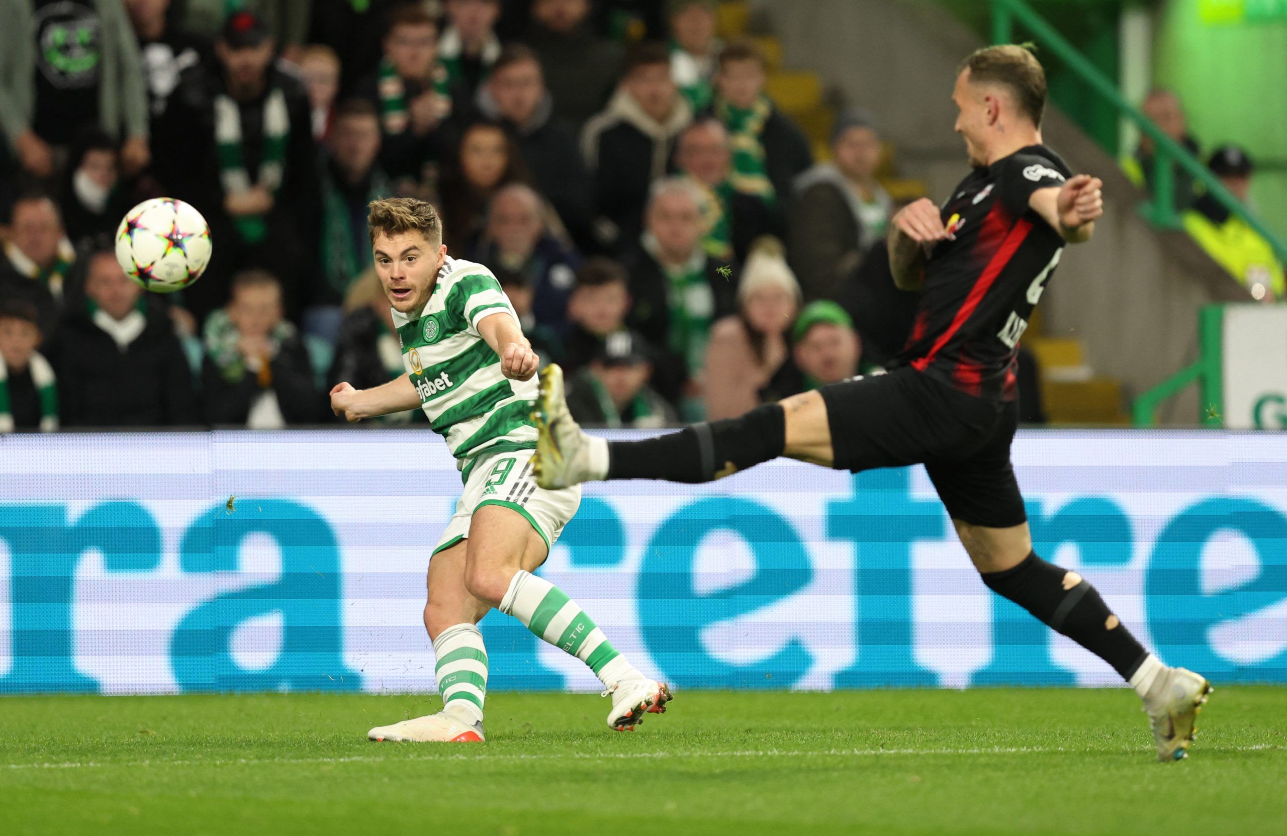 Soccer Football - Champions League - Group F - Celtic v RB Leipzig - Celtic Park, Glasgow, Scotland, Britain - October 11, 2022  Celtic's James Forrest in action with RB Leipzig's David Raum REUTERS/Russell Cheyne