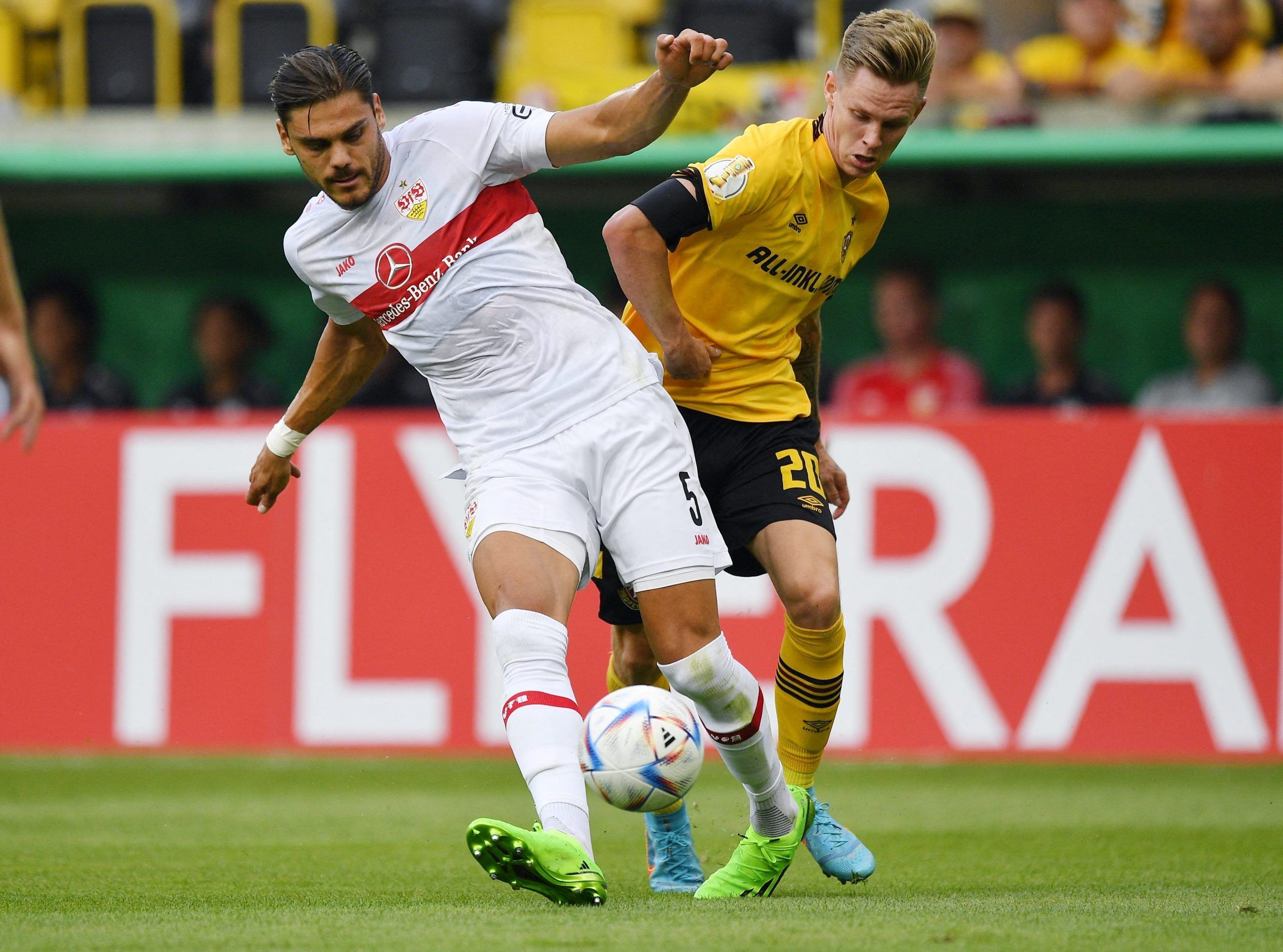 Soccer Football - DFB Cup - First Round - Dynamo Dresden v VfB Stuttgart - Rudolf Harbig Stadion, Dresden, Germany - July 29, 2022 VfB Stuttgart's Konstantinos Mavropanos in action with Dynamo Dresden's Julius Kade REUTERS/Matthias Rietschel DFB REGULATIONS PROHIBIT ANY USE OF PHOTOGRAPHS AS IMAGE SEQUENCES AND/OR QUASI-VIDEO.