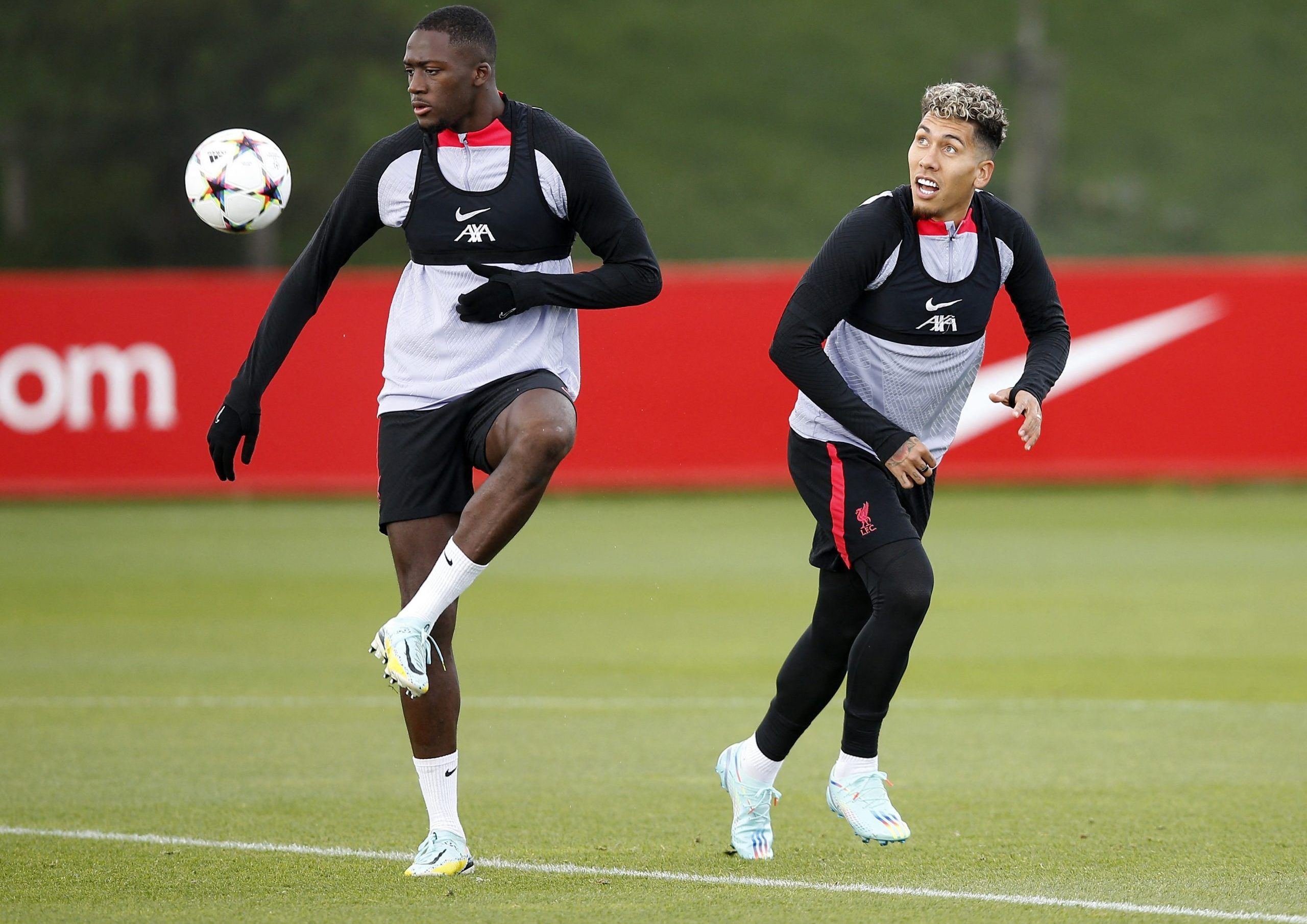 Soccer Football - Champions League - Liverpool Training - AXA Training Centre, Liverpool, Britain - October 11, 2022 Liverpool's Ibrahima Konate and Roberto Firmino during training Action Images via Reuters/Craig Brough