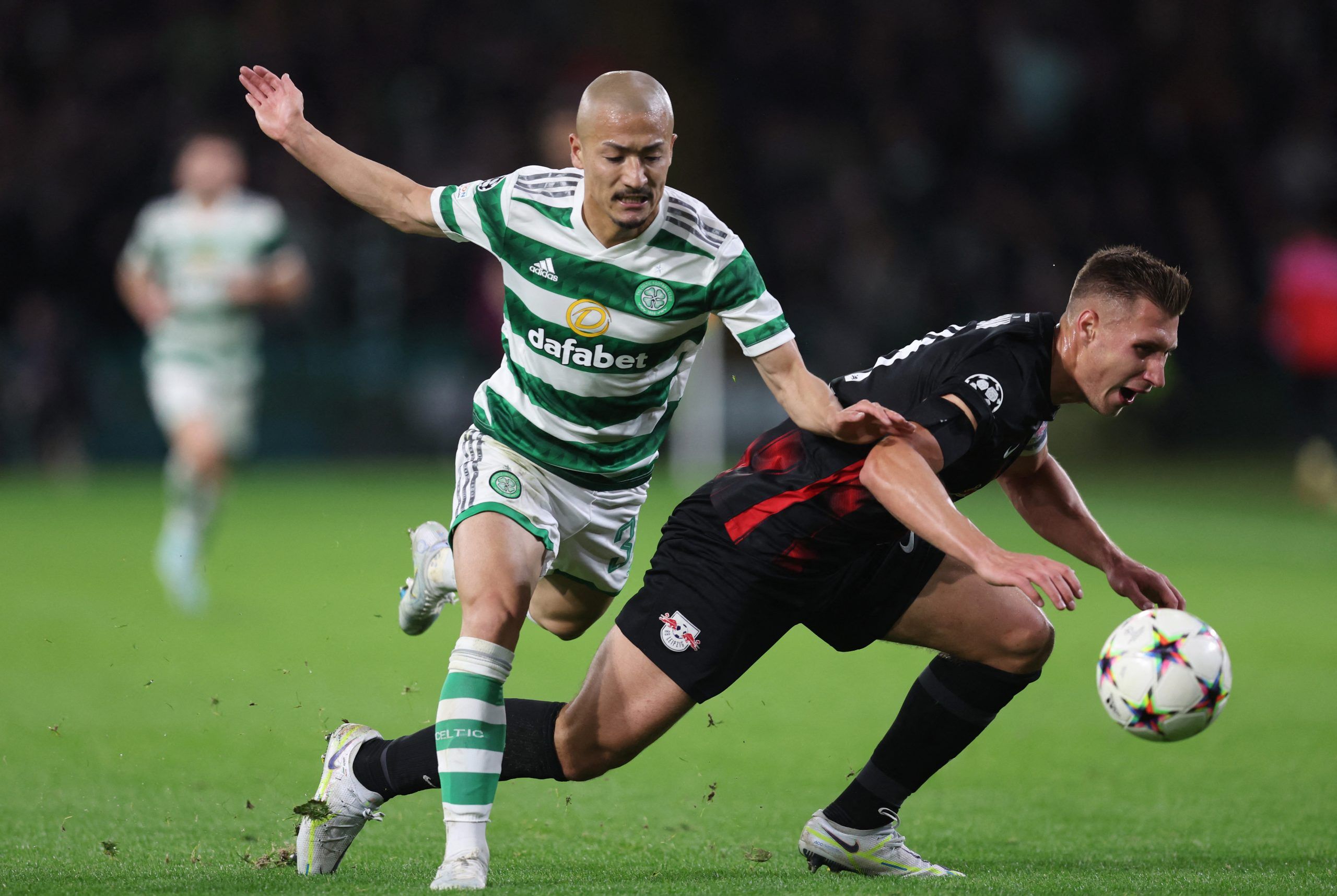 Soccer Football - Champions League - Group F - Celtic v RB Leipzig - Celtic Park, Glasgow, Scotland, Britain - October 11, 2022  RB Leipzig's Willi Orban in action with Celtic's Daizen Maeda REUTERS/Russell Cheyne