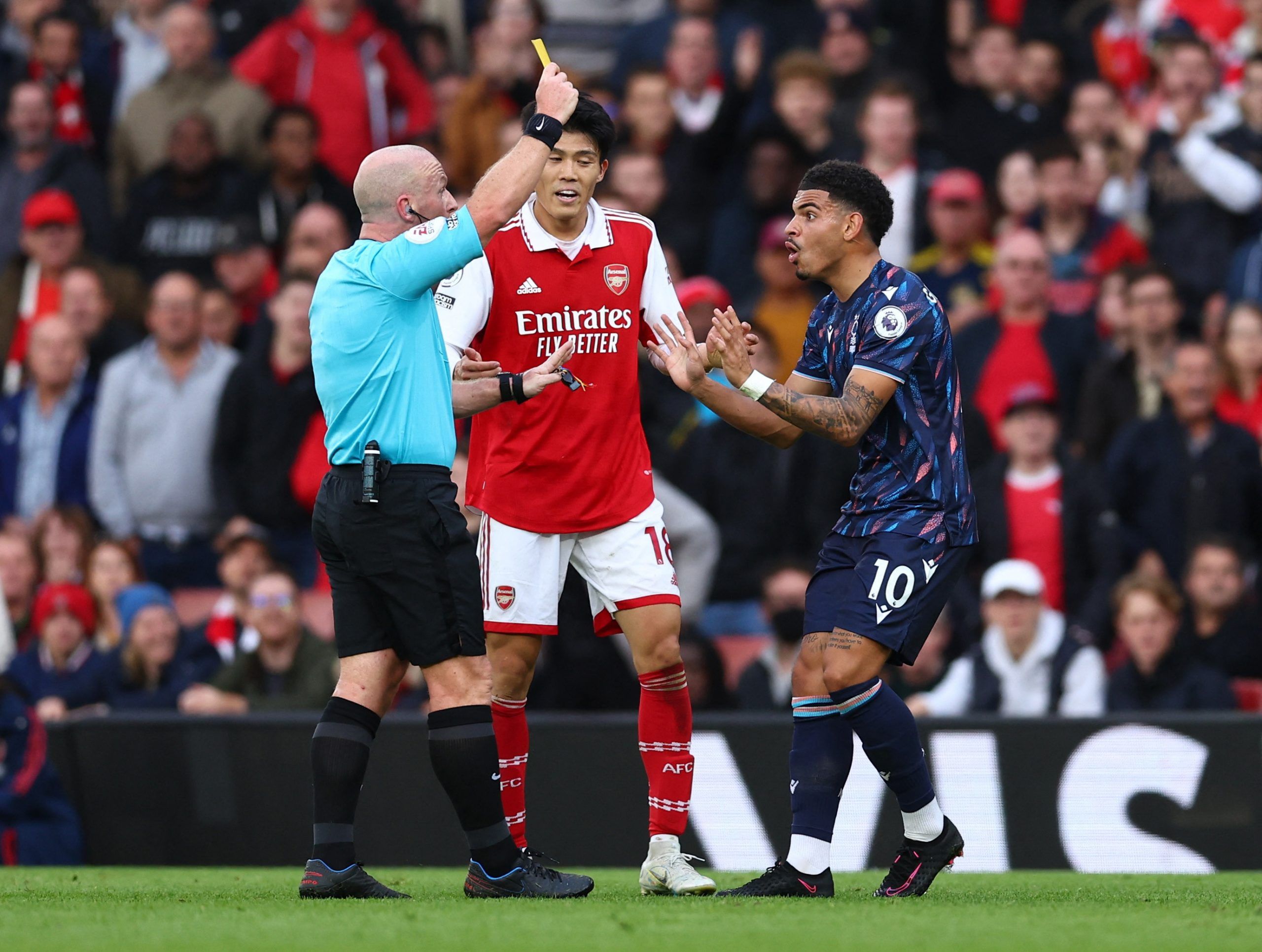 Soccer Football - Premier League - Arsenal v Nottingham Forest - Emirates Stadium, London, Britain - October 30, 2022 Nottingham Forest's Morgan Gibbs-White is shown a yellow card by referee Simon Hooper REUTERS/David Klein EDITORIAL USE ONLY. No use with unauthorized audio, video, data, fixture lists, club/league logos or 'live' services. Online in-match use limited to 75 images, no video emulation. No use in betting, games or single club /league/player publications. Please contact your accoun