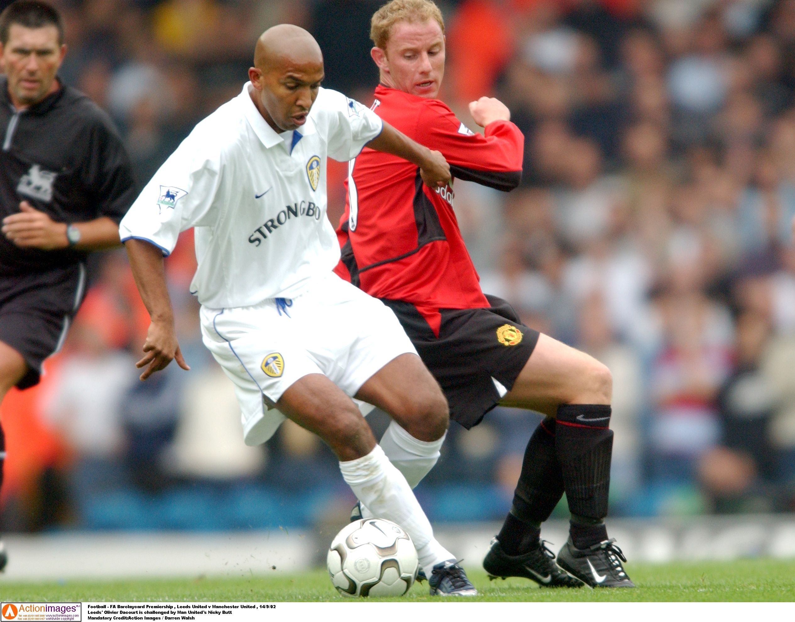 Football - FA Barclaycard Premiership , Leeds United v Manchester United , 14/9/02 
Leeds' Olivier Dacourt is challenged by Man United's Nicky Butt 
Mandatory Credit:Action Images / Darren Walsh