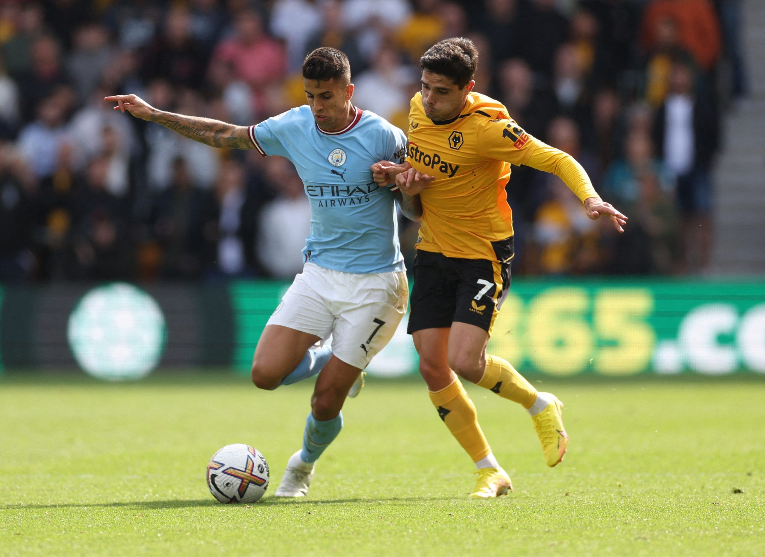 Soccer Football - Premier League - Wolverhampton Wanderers v Manchester City - Molineux Stadium, Wolverhampton, Britain - September 17, 2022 Wolverhampton Wanderers' Pedro Neto in action with Manchester City's Joao Cancelo Action Images via Reuters/Carl Recine EDITORIAL USE ONLY. No use with unauthorized audio, video, data, fixture lists, club/league logos or 'live' services. Online in-match use limited to 75 images, no video emulation. No use in betting, games or single club /league/player publ