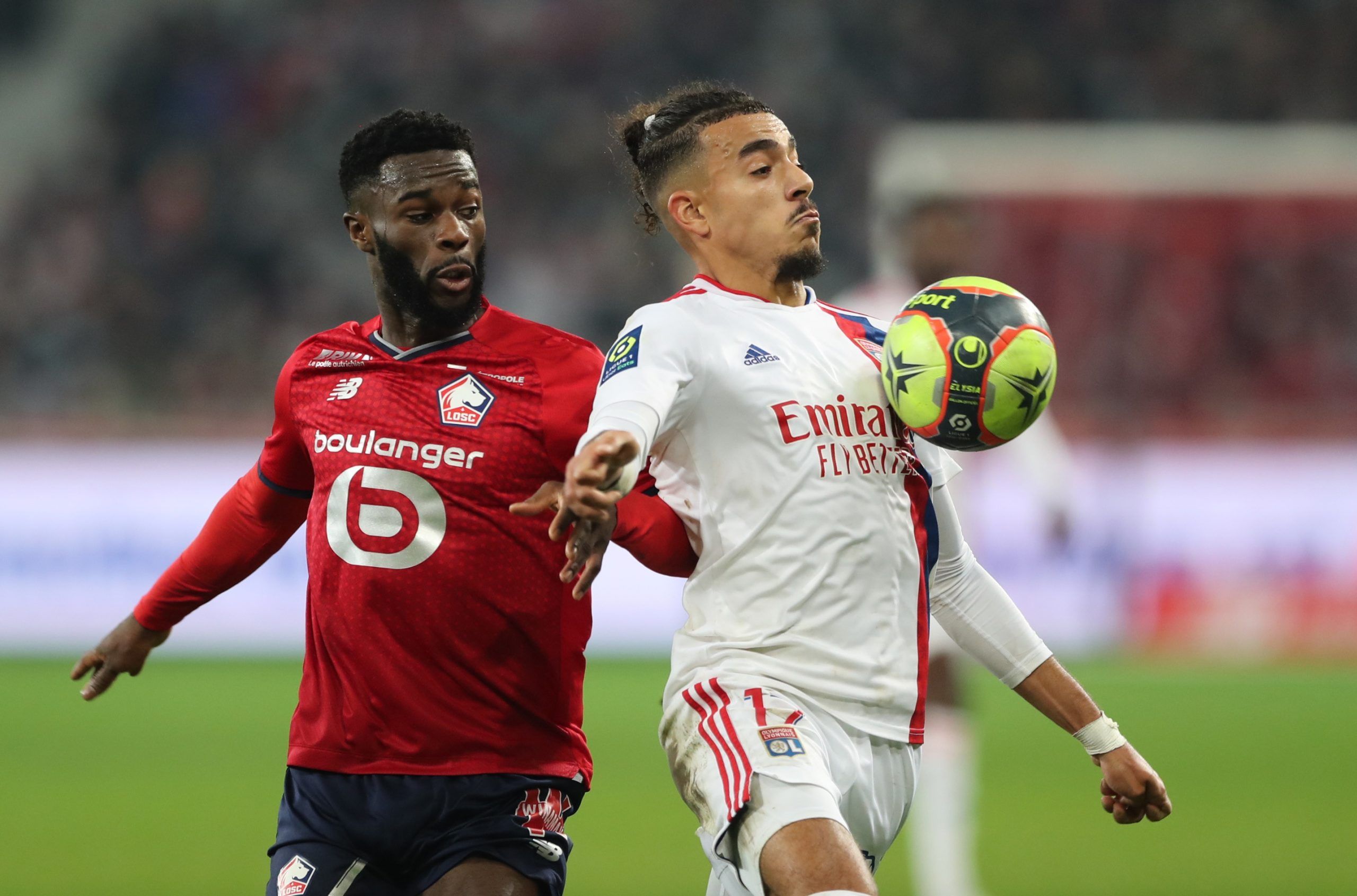 Soccer Football - Ligue 1 - Lille v Olympique Lyonnais - Stade Pierre-Mauroy, Villeneuve-d'Ascq, France - December 12, 2021 Olympique Lyonnais' Malo Gusto in action with Lille's Jonathan Bamba REUTERS/Pascal Rossignol