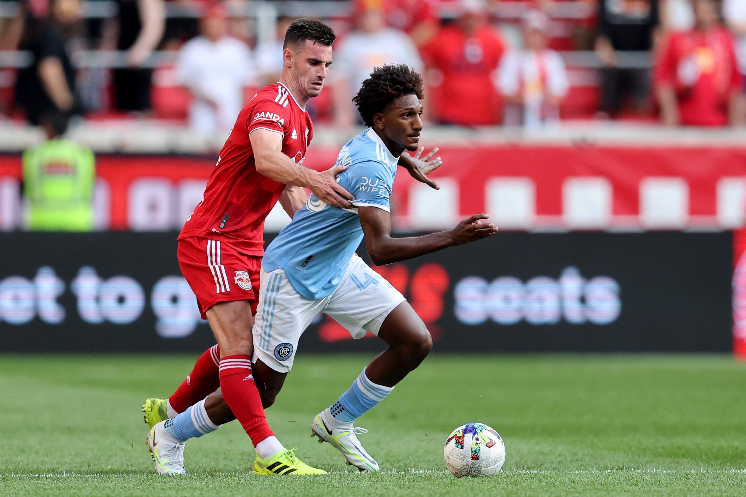 Jul 17, 2022; Harrison, New Jersey, USA; New York Red Bulls defender Dylan Nealis (12) and New York City forward Talles Magno (43) fight for the ball during the second half at Red Bull Arena. Mandatory Credit: Brad Penner-USA TODAY Sports