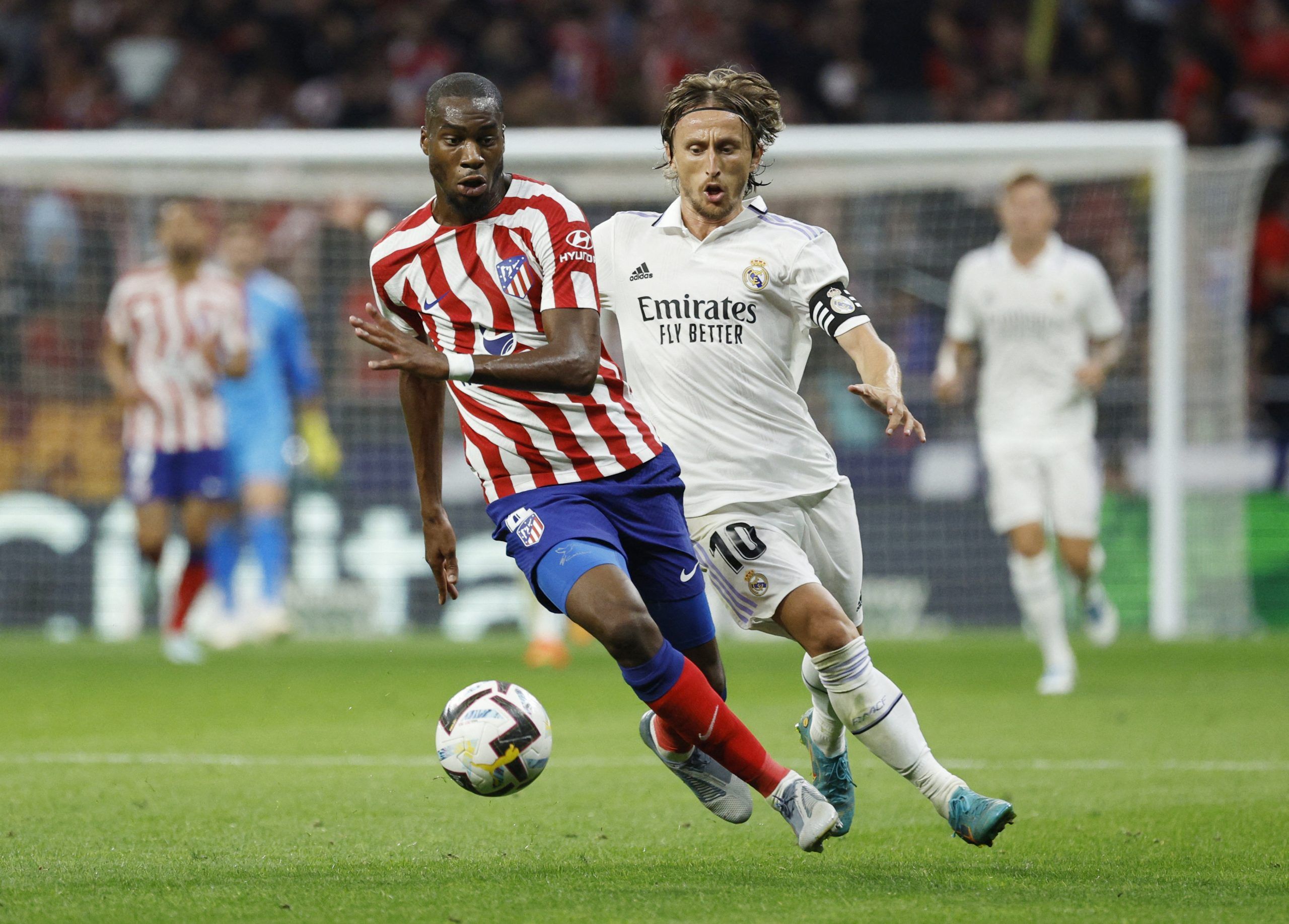 Atletico Madrid's Geoffrey Kondogbia in action with Real Madrid's Luka Modric