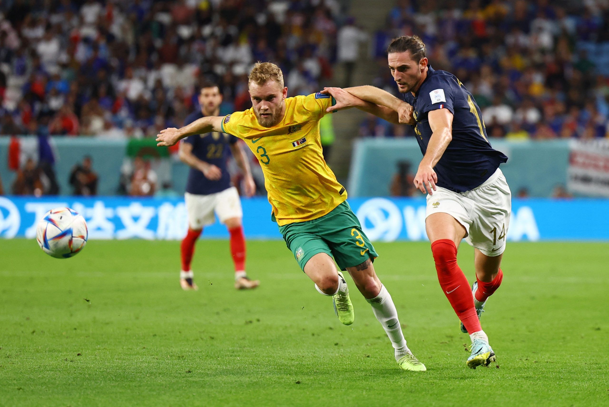 Australia's Nathaniel Atkinson in action with France's Adrien Rabiot
