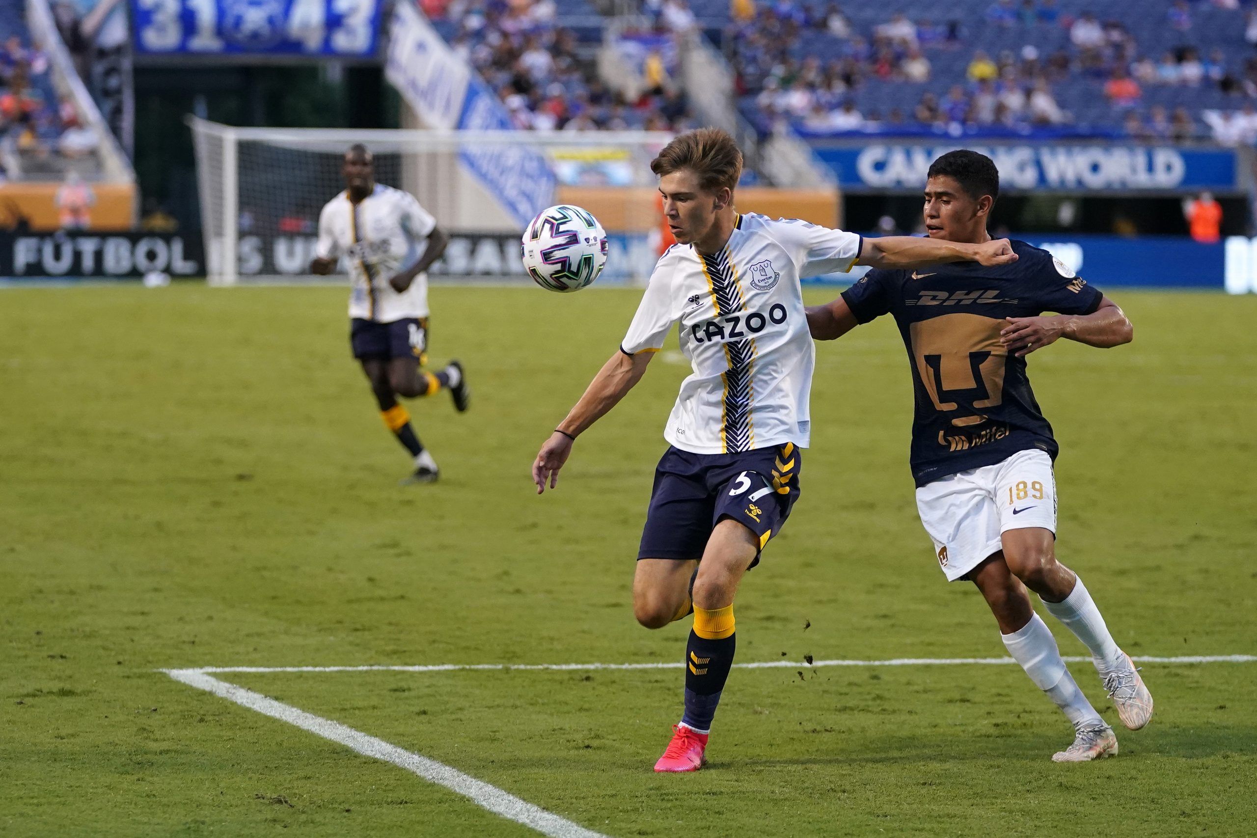 Jul 28, 2021; Orlando, Florida, USA; Everton forward Charlie Whitaker (57) plays the ball in front of UNAM Pumas defender Jesus Rivas (189) in the second half of the 2021 Florida Cup friendly soccer match at Camping World Stadium. Mandatory Credit: Jasen Vinlove-USA TODAY Sports