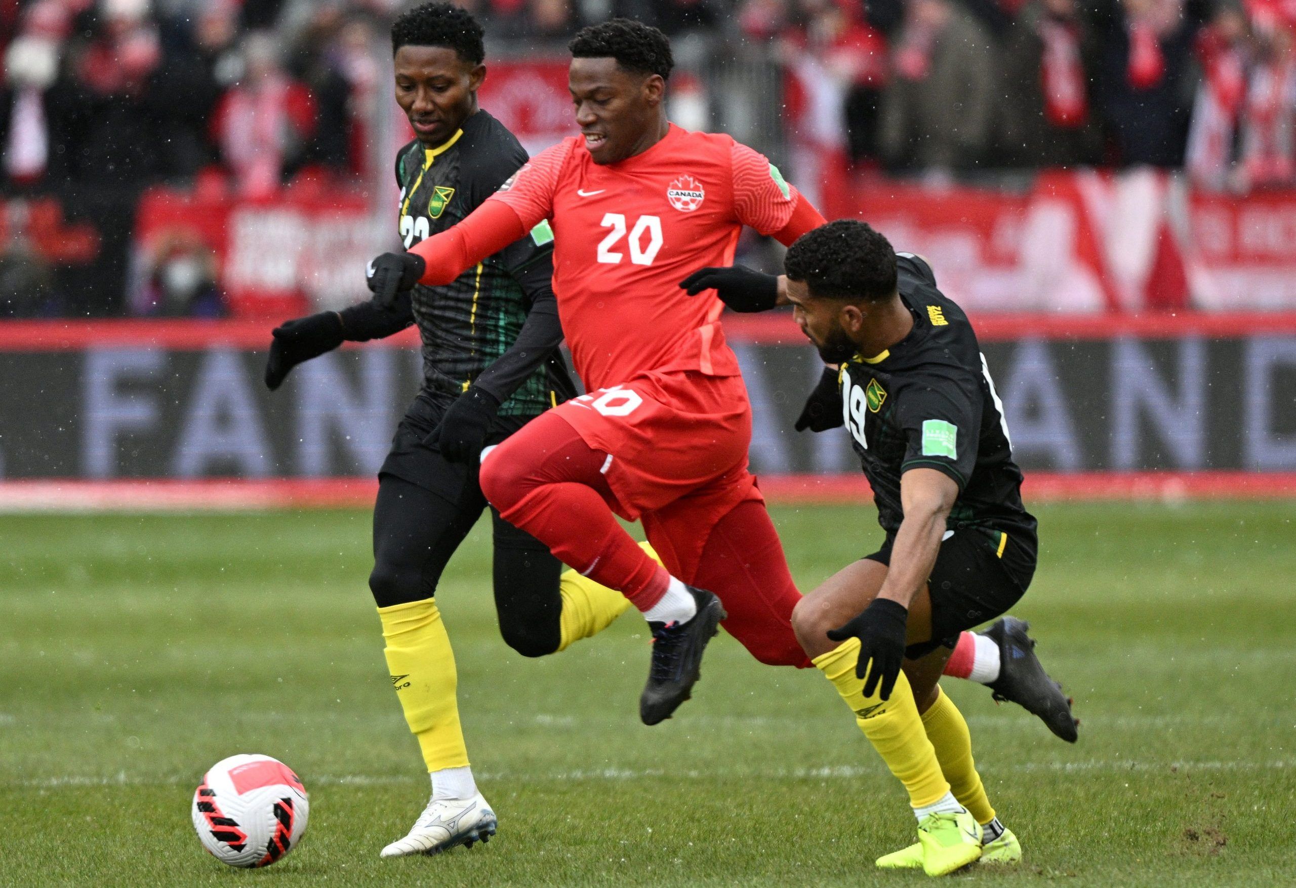 FILE PHOTO: Mar 27, 2022; Toronto, Ontario, CAN;   Canada forward Jonathan David (20) dribbles the ball between Jamaica midfielders Richard King (6) and Adrian Mariappa (19) in the first half of a FIFA World Cup qualifying soccer match at BMO Field. Mandatory Credit: Dan Hamilton-USA TODAY Sports/File Photo