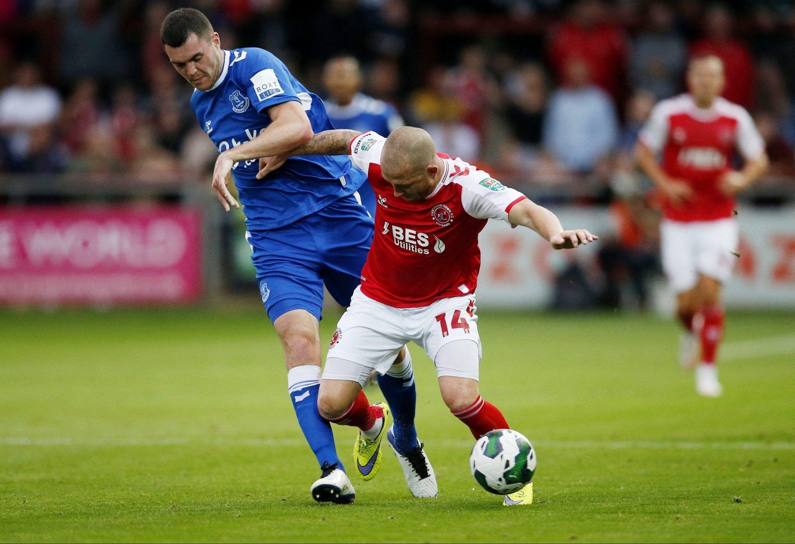 Soccer Football - Carabao Cup Second Round - Fleetwood Town v Everton - Highbury Stadium, Fleetwood, Britain - August 23, 2022 Everton's Michael Keane in action with Fleetwood Town's Joe Garner Action Images via Reuters/Ed Sykes EDITORIAL USE ONLY. No use with unauthorized audio, video, data, fixture lists, club/league logos or 'live' services. Online in-match use limited to 75 images, no video emulation. No use in betting, games or single club /league/player publications.  Please contact your a