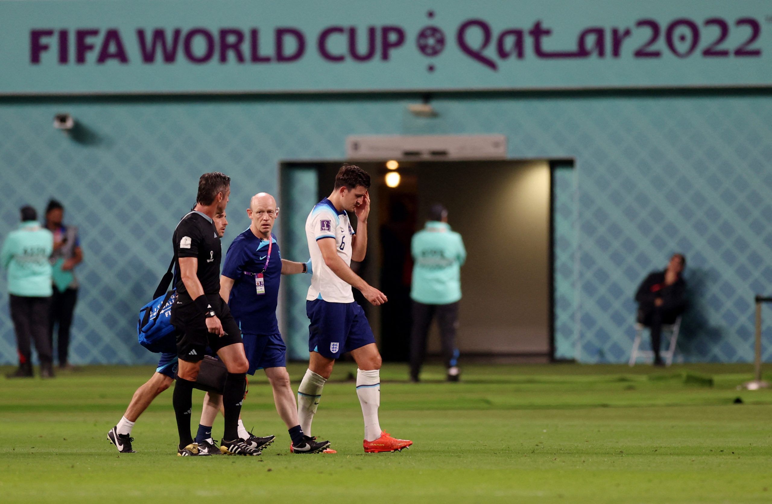 Soccer Football - FIFA World Cup Qatar 2022 - Group B - England v Iran - Khalifa International Stadium, Doha, Qatar - November 21, 2022 England's Harry Maguire receives medical attention after sustaining an injury REUTERS/Lee Smith