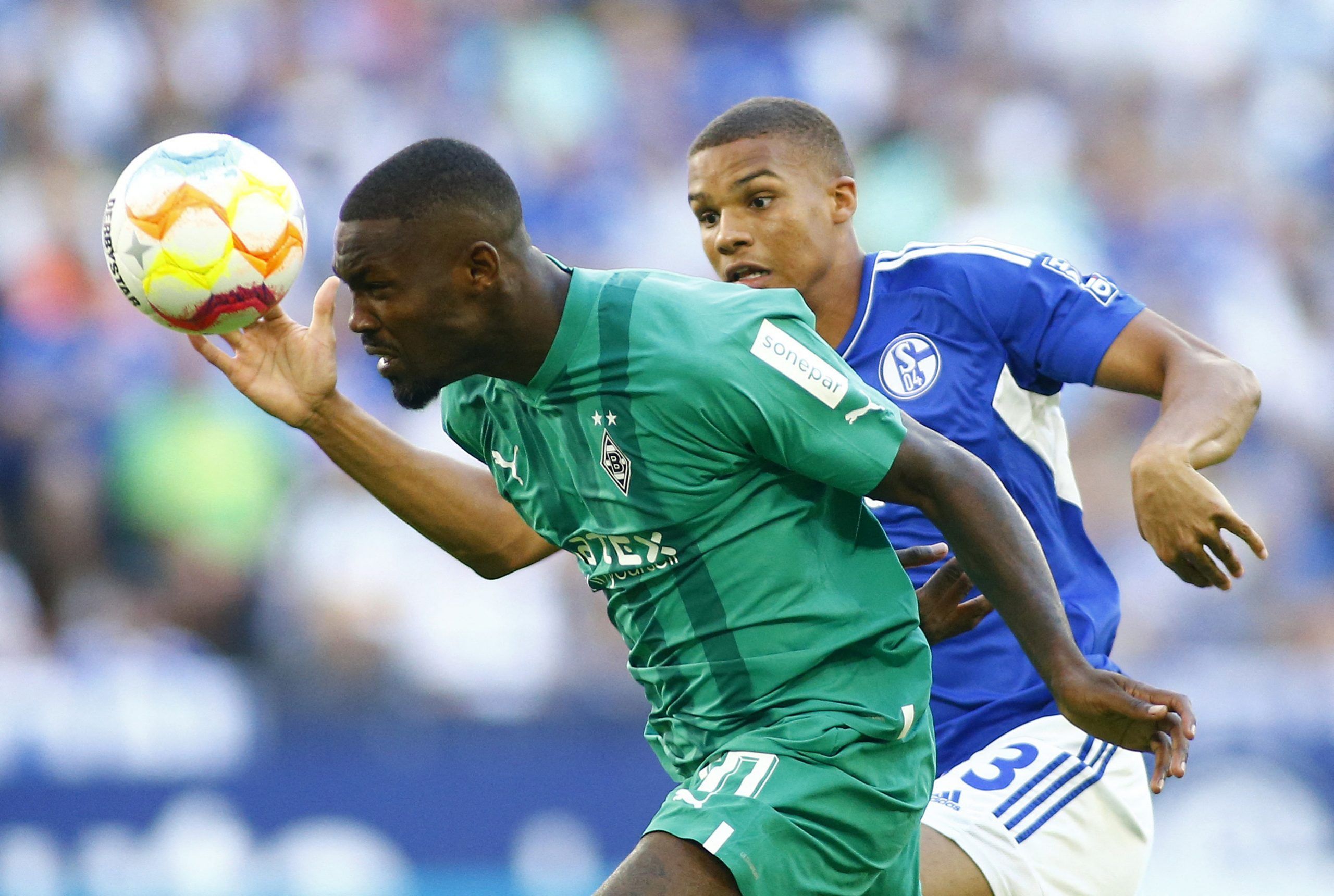 Soccer Football - Bundesliga - Schalke 04 v Borussia Moenchengladbach - Veltins-Arena, Gelsenkirchen, Germany - August 13, 2022  Borussia Moenchengladbach's Marcus Thuram in action with Schalke 04's Malick Thiaw REUTERS/Thilo Schmuelgen DFL REGULATIONS PROHIBIT ANY USE OF PHOTOGRAPHS AS IMAGE SEQUENCES AND/OR QUASI-VIDEO.