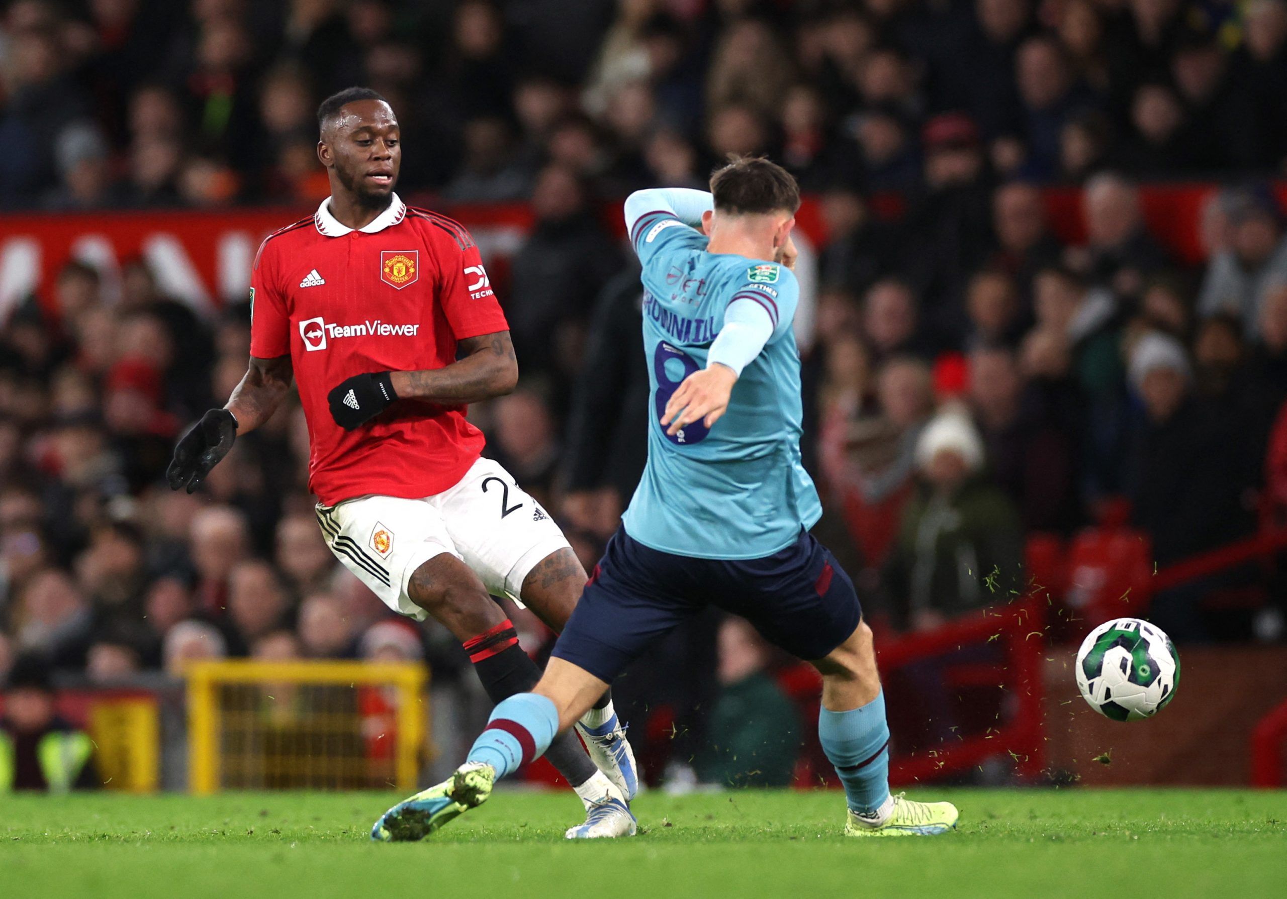 Soccer Football - Carabao Cup - Round of 16 - Manchester United v Burnley - Old Trafford, Manchester, Britain - December 21, 2022 Manchester United's Aaron Wan-Bissaka in action with Burnley's Josh Brownhill Action Images via Reuters/Phil Noble EDITORIAL USE ONLY. No use with unauthorized audio, video, data, fixture lists, club/league logos or 'live' services. Online in-match use limited to 75 images, no video emulation. No use in betting, games or single club /league/player publications.  Pleas
