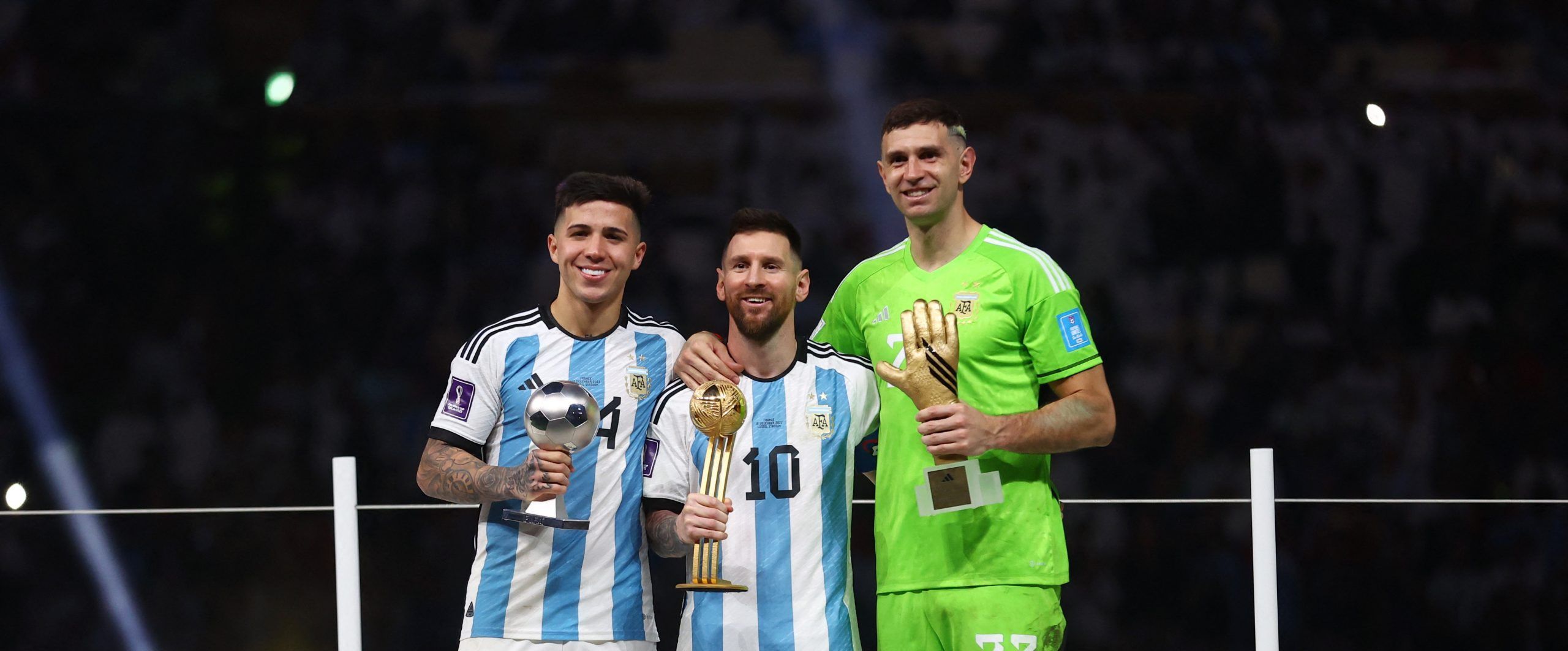 Soccer Football - FIFA World Cup Qatar 2022 - Final - Argentina v France - Lusail Stadium, Lusail, Qatar - December 18, 2022 Best Young Player winner Argentina's Enzo Fernandez, Golden Ball winner Argentina's Lionel Messi and Golden Glove winner Argentina's Emiliano Martinez pose with the trophies REUTERS/Carl Recine