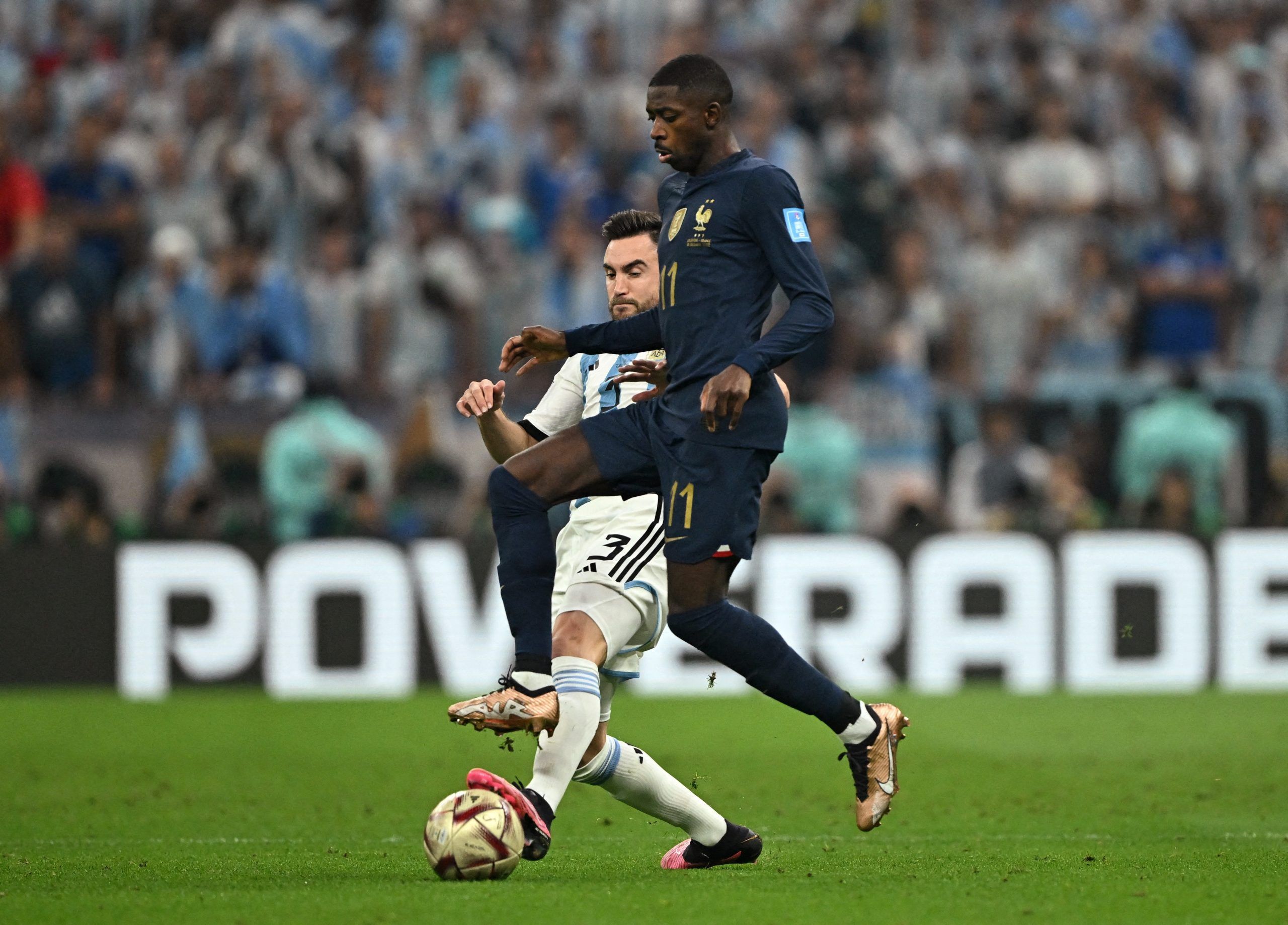 Soccer Football - FIFA World Cup Qatar 2022 - Final - Argentina v France - Lusail Stadium, Lusail, Qatar - December 18, 2022  Argentina's Nicolas Tagliafico in action with France's Ousmane Dembele REUTERS/Dylan Martinez