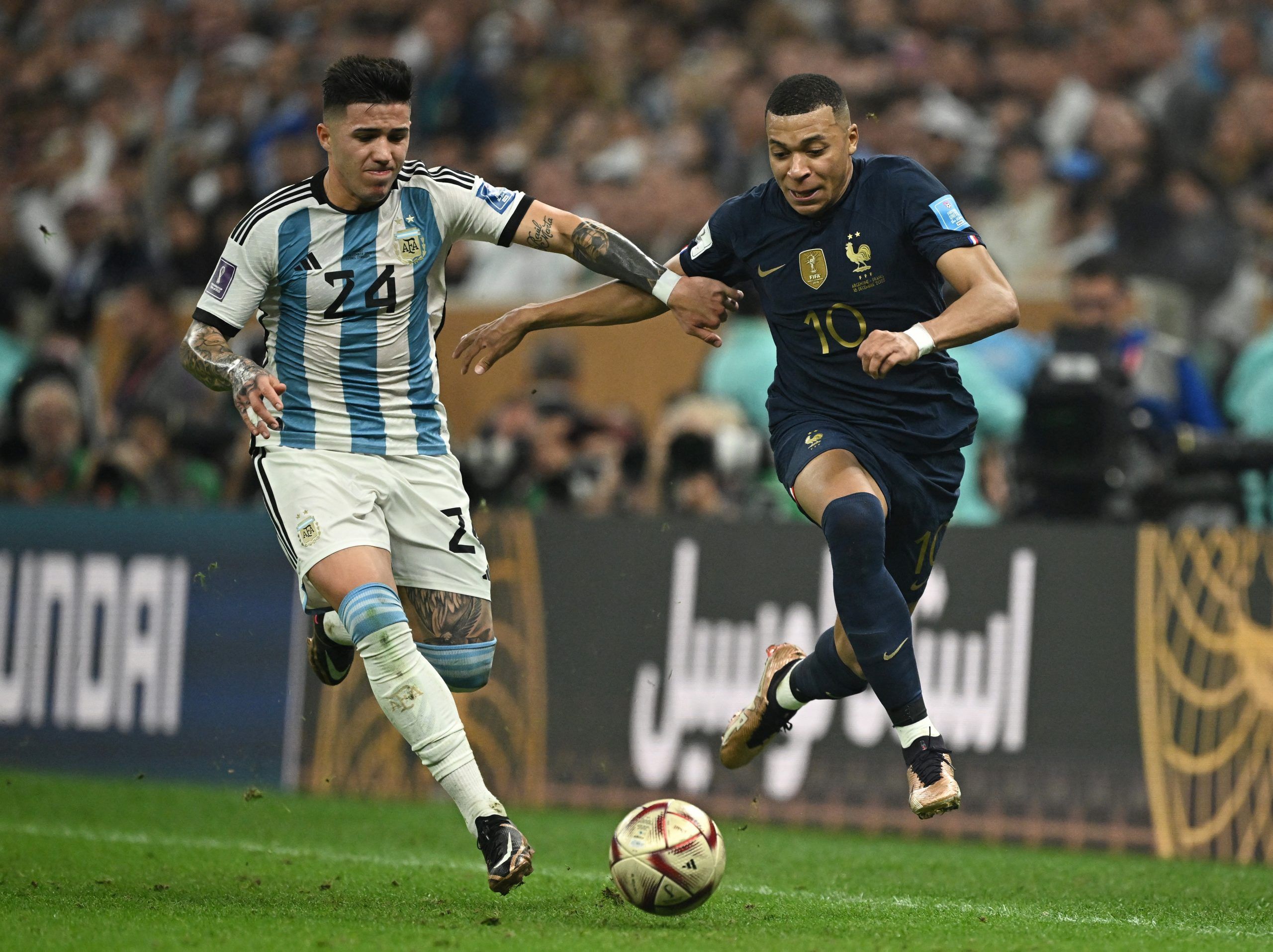 Soccer Football - FIFA World Cup Qatar 2022 - Final - Argentina v France - Lusail Stadium, Lusail, Qatar - December 18, 2022  France's Kylian Mbappe in action with Argentina's Enzo Fernandez REUTERS/Dylan Martinez