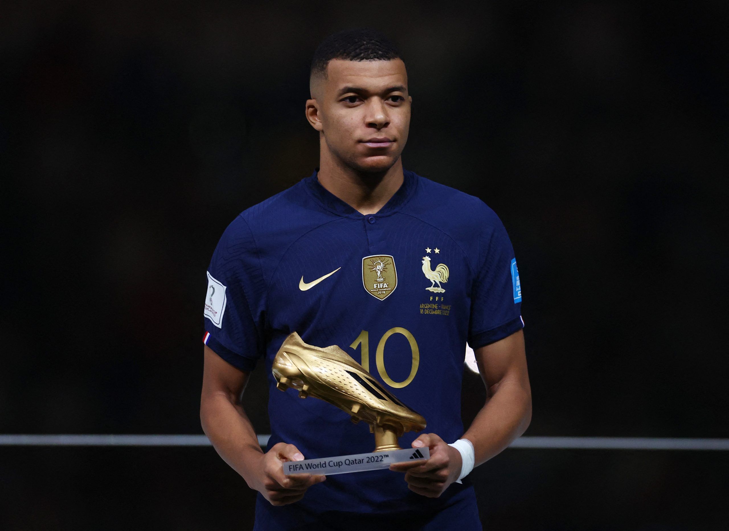 Soccer Football - FIFA World Cup Qatar 2022 - Final - Argentina v France - Lusail Stadium, Lusail, Qatar - December 18, 2022 France's Kylian Mbappe poses with his Golden Boot award during the award ceremony after the match REUTERS/Kai Pfaffenbach
