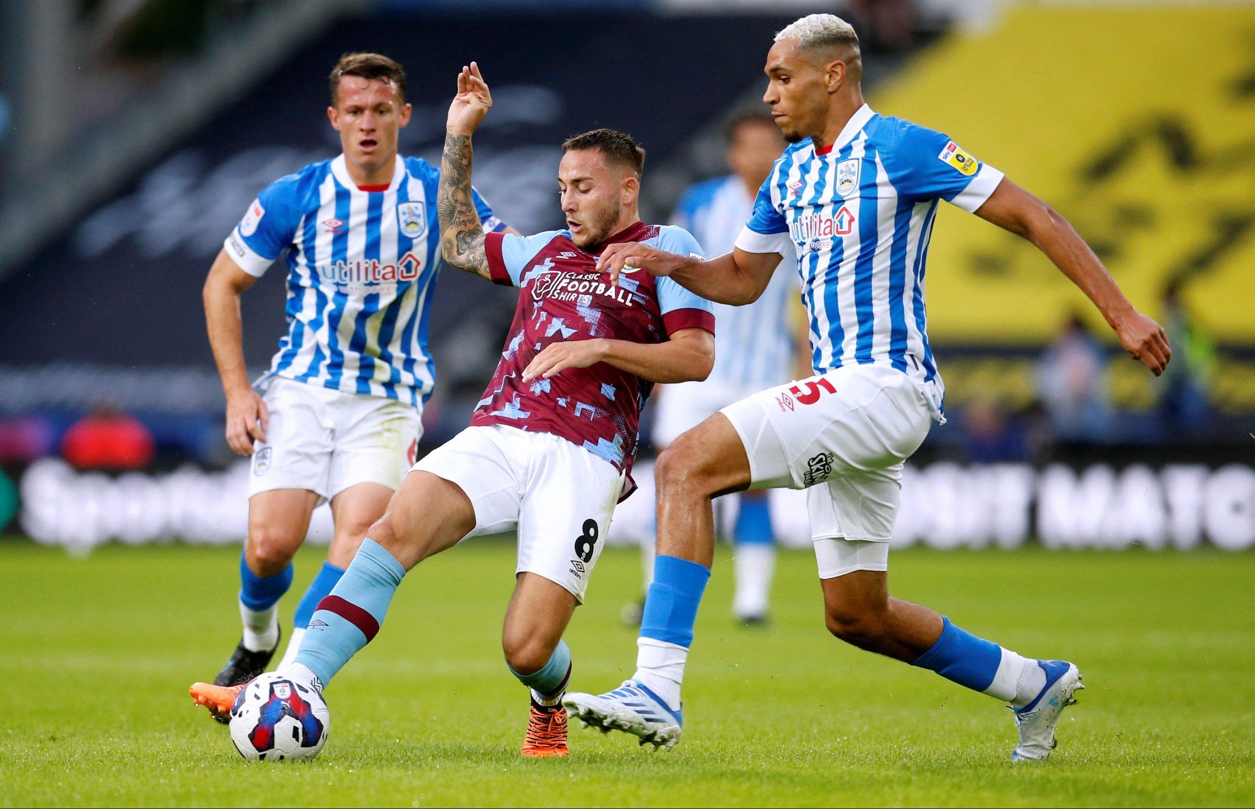 Soccer Football - Championship - Huddersfield Town v Burnley - John Smith's Stadium, Huddersfield, Britain - July 29, 2022  Burnley's Josh Brownhill in action with Huddersfield Town's Jon Russell  Action Images/Ed Sykes  EDITORIAL USE ONLY. No use with unauthorized audio, video, data, fixture lists, club/league logos or 