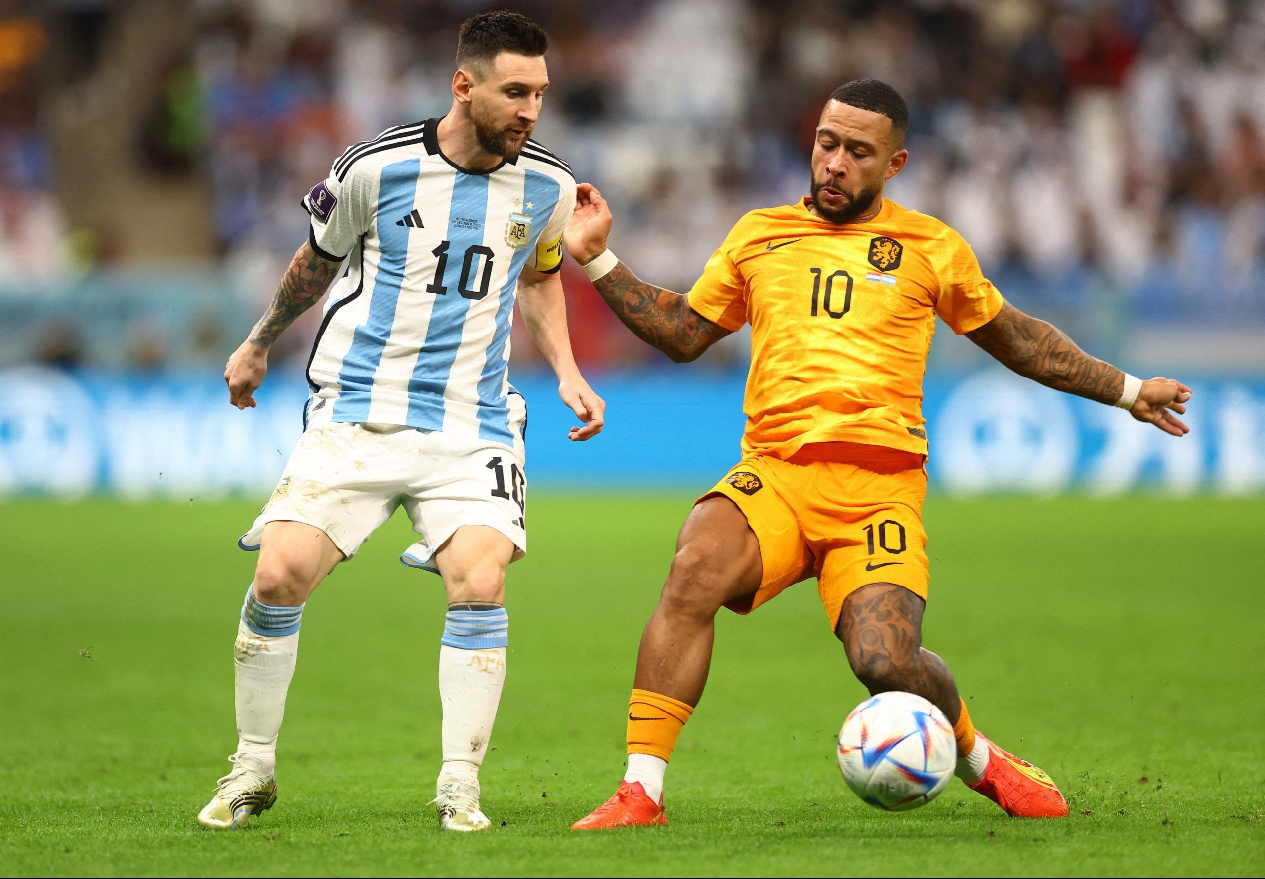Soccer Football - FIFA World Cup Qatar 2022 - Quarter Final - Netherlands v Argentina - Lusail Stadium, Lusail, Qatar - December 9, 2022  Argentina's Lionel Messi in action with  Netherlands' Memphis Depay REUTERS/Carl Recine
